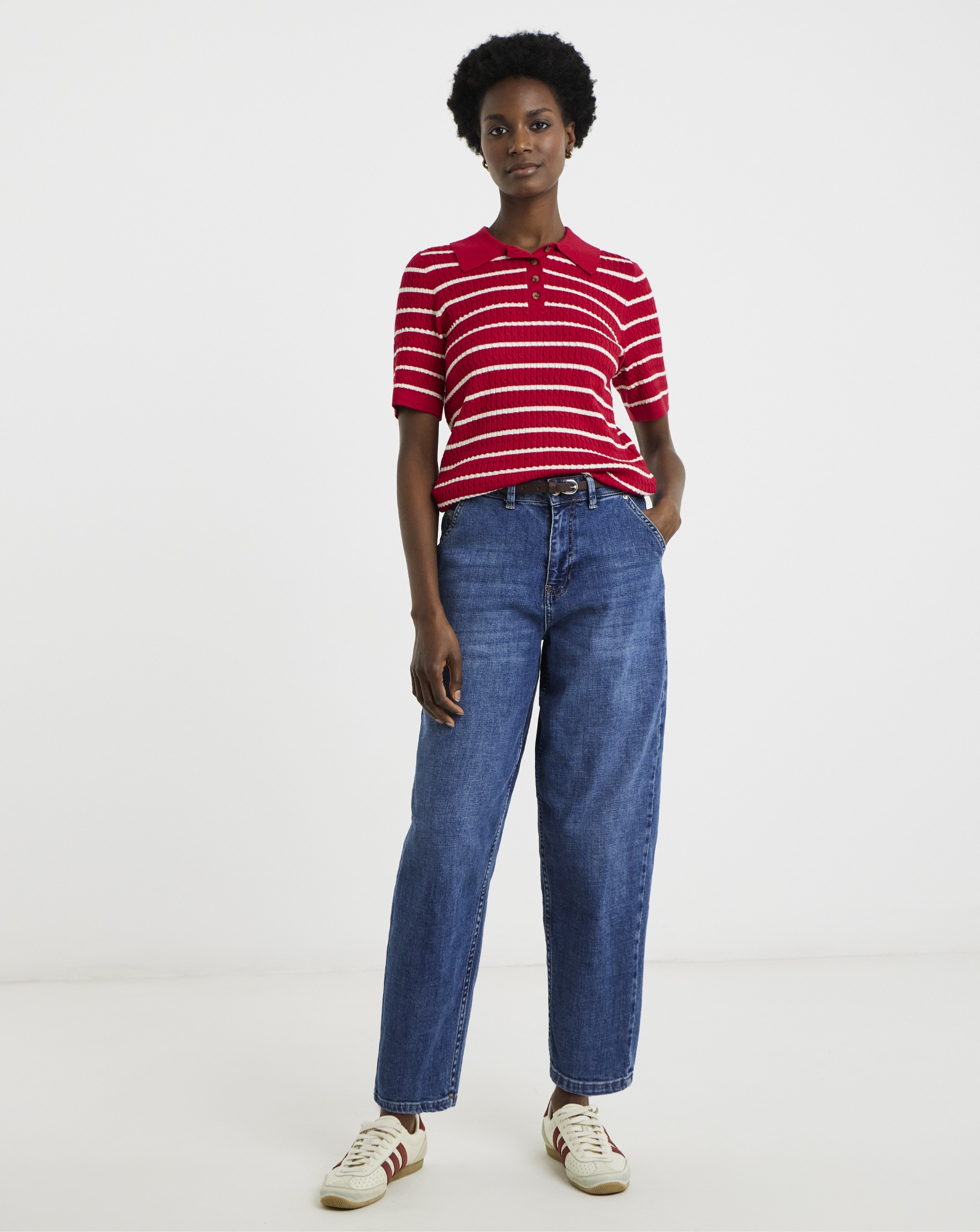 Woman wearing red and white stripped top and denim jeans