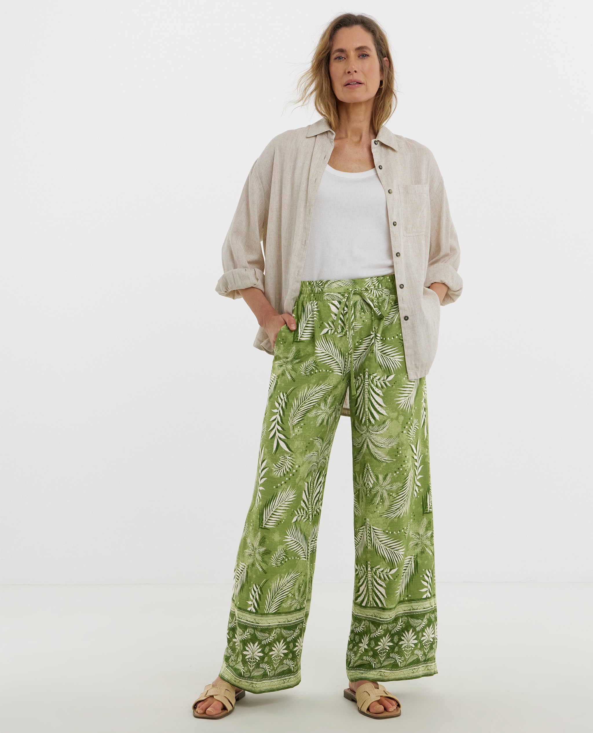 Model wears linen shirt and green print casual trousers