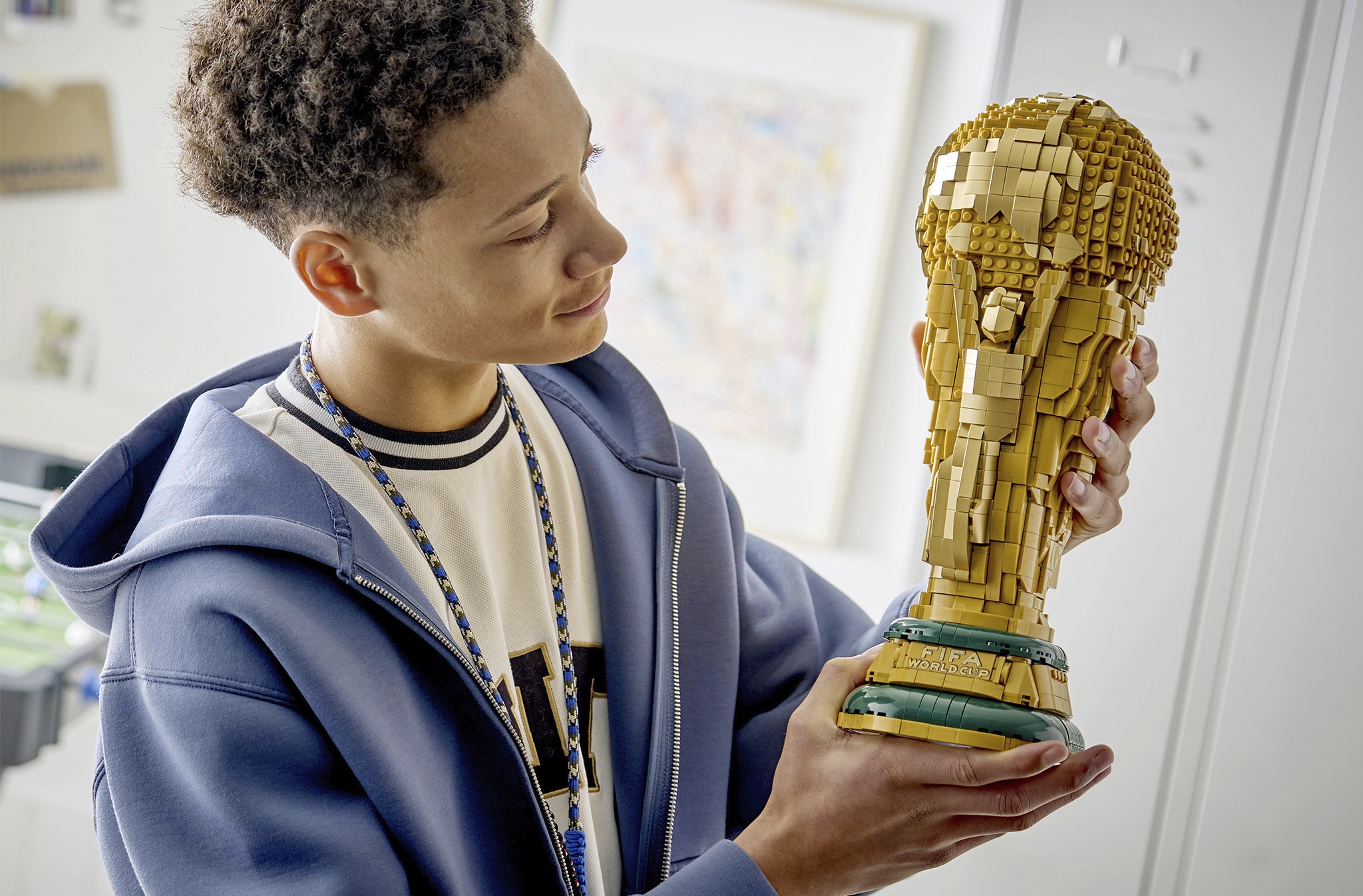 A child holding a LEGO® World cup trophy building set.
