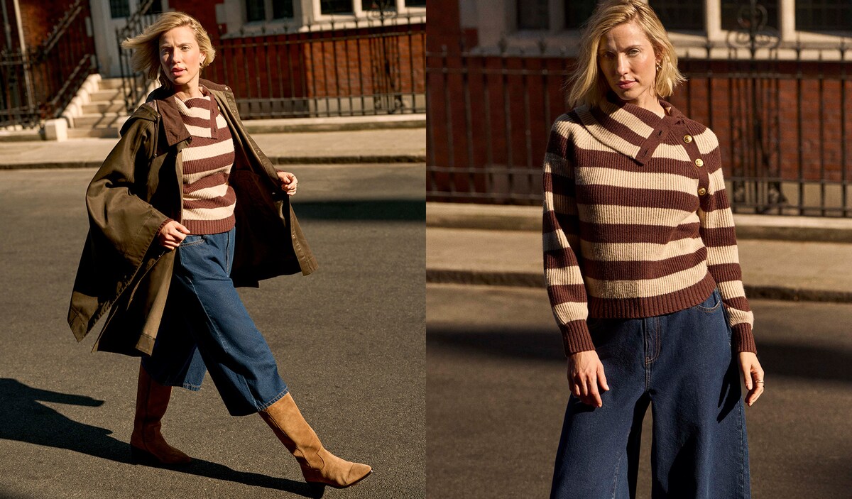 A lady walking in a street wearing a brown and light brown striped jumper.