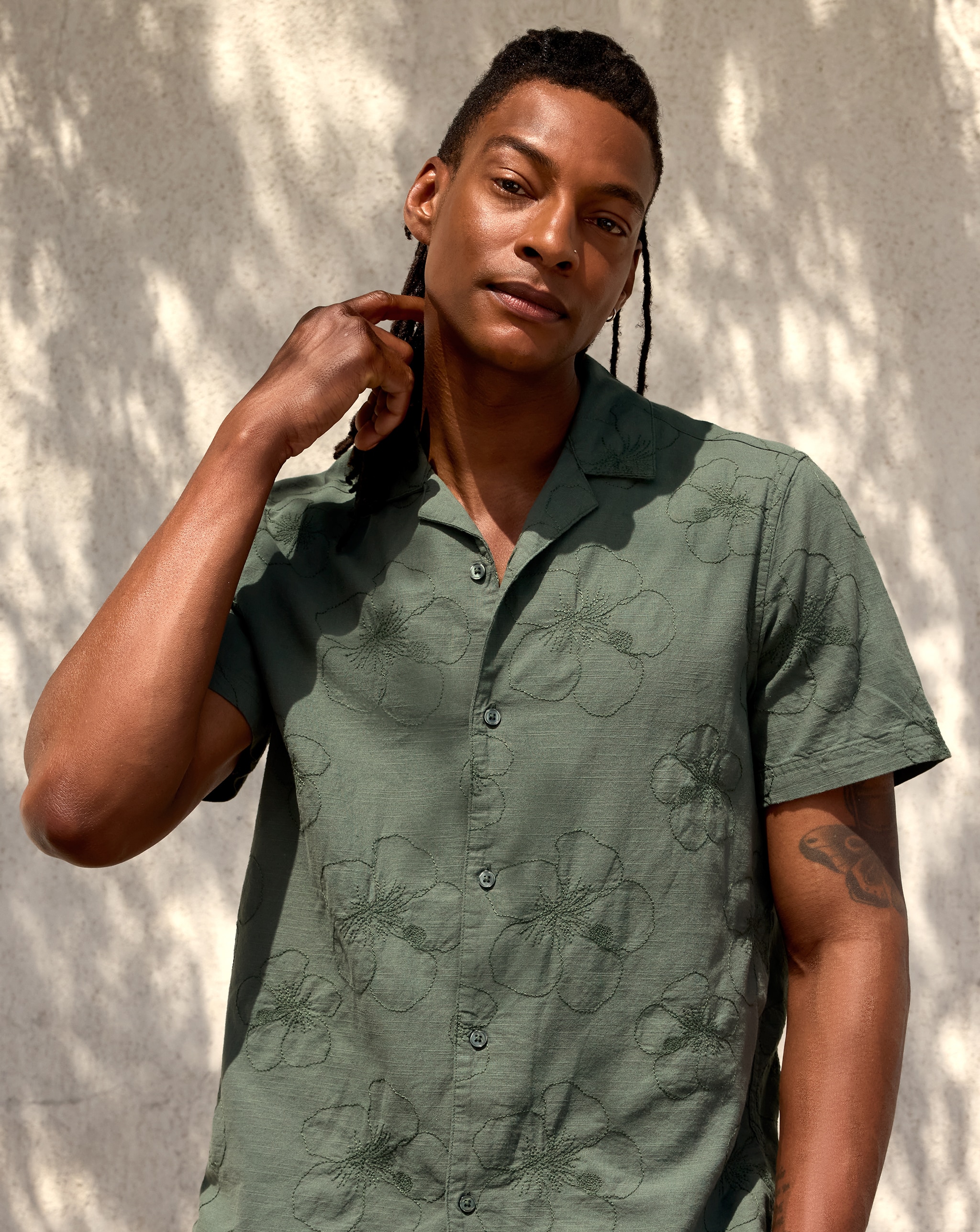 Model is wearing a khaki revere collar floral embroidered co-ord shirt.
