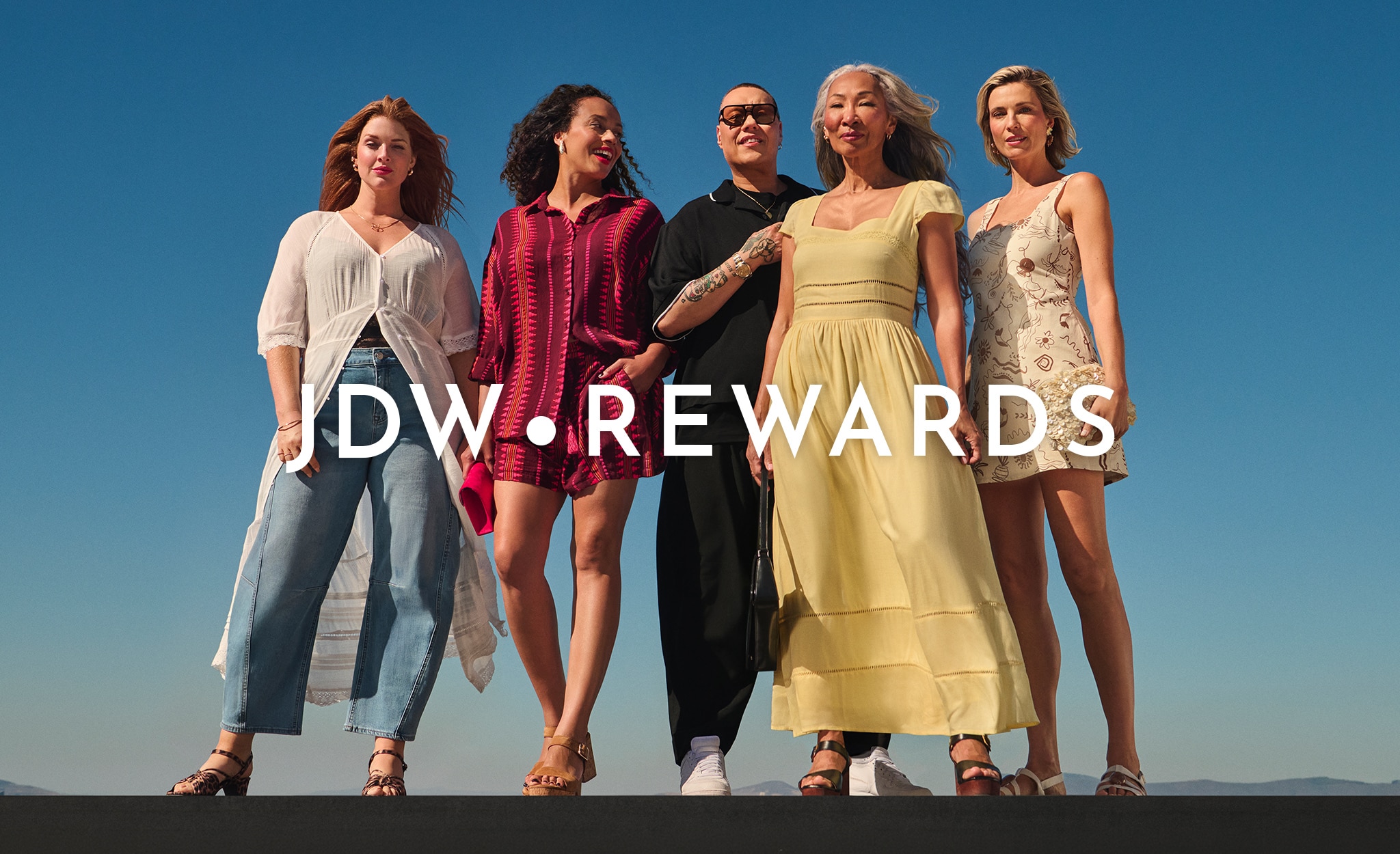 4 ladies and Gok Wan standing in front of a blue sky.