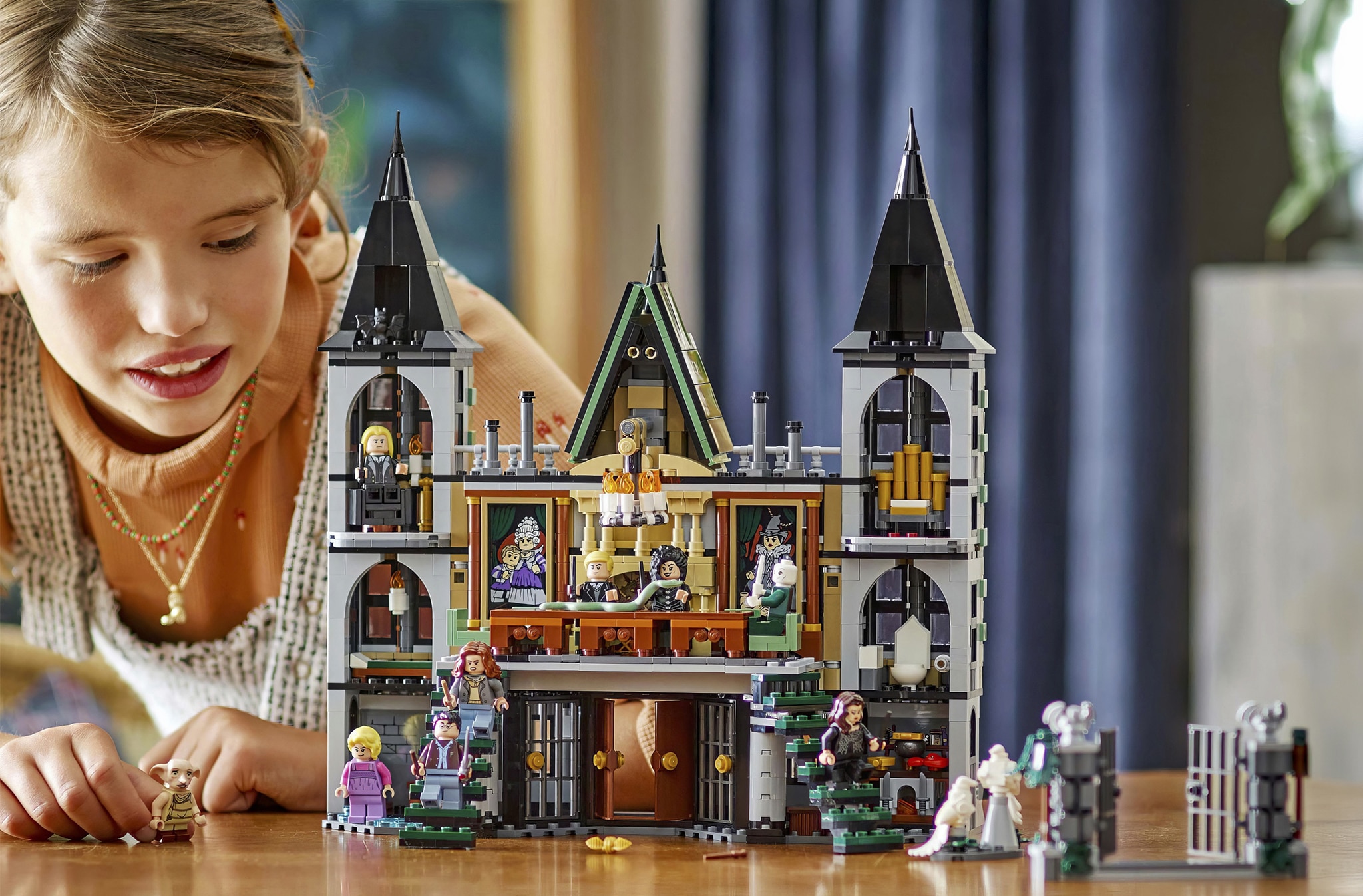 A child building a Harry Potter™ LEGO® castle.
