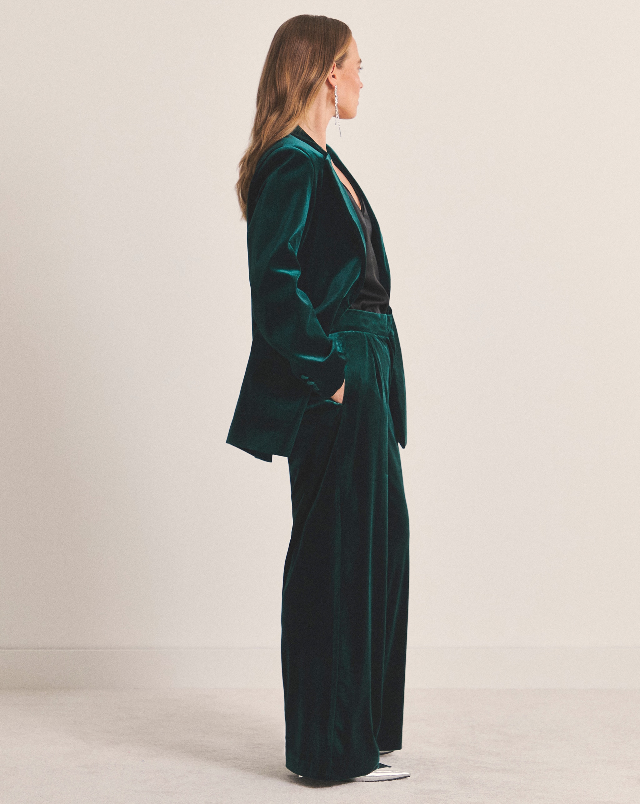 Person wearing a green Simply Be velvet single breasted blazer and trousers