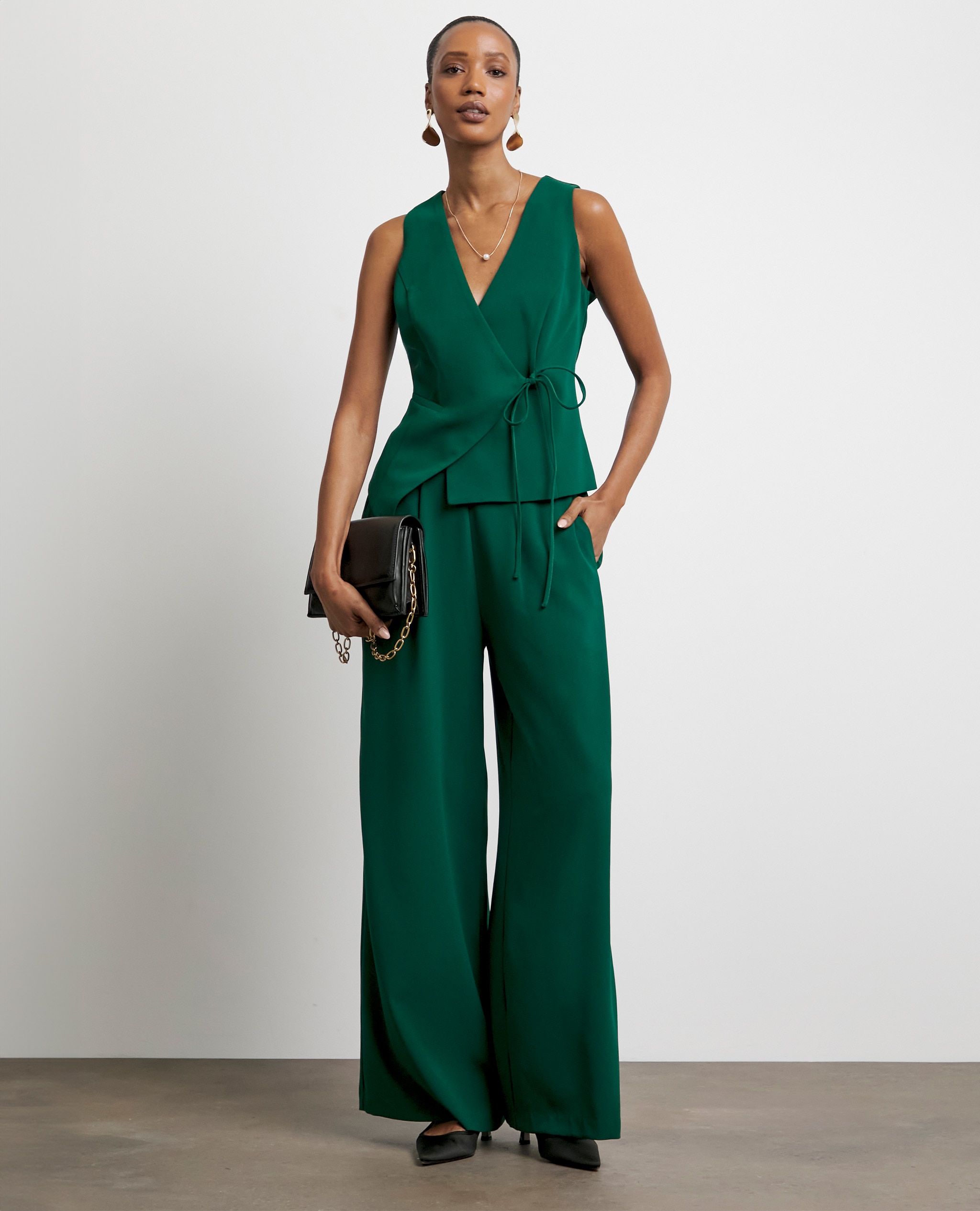 Model wearing green trousers and a matching wrap top