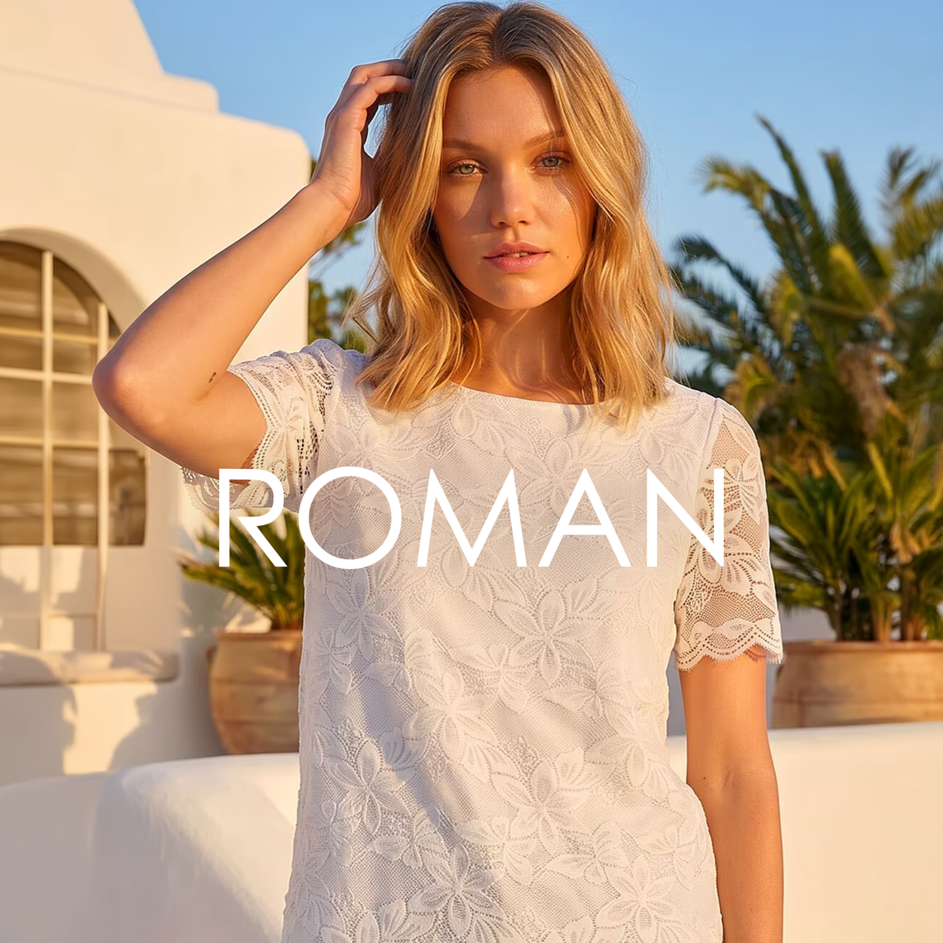 A woman wearing a Roman Ivory coloured floral lace top.