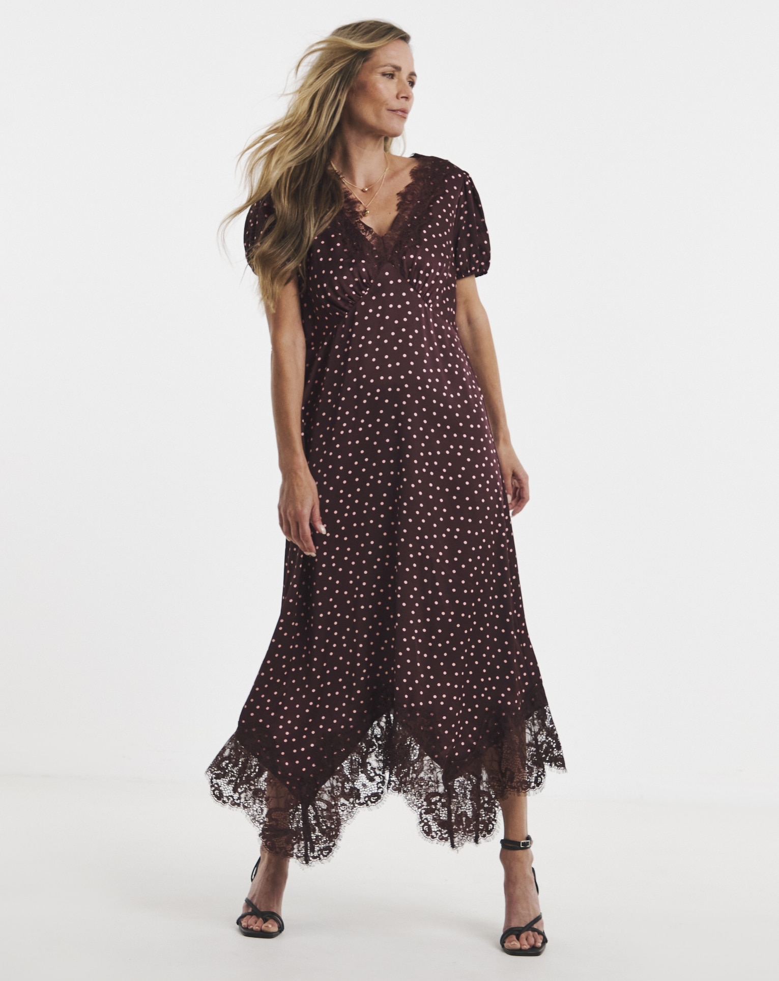 Woman wearing spotted burgundy dress