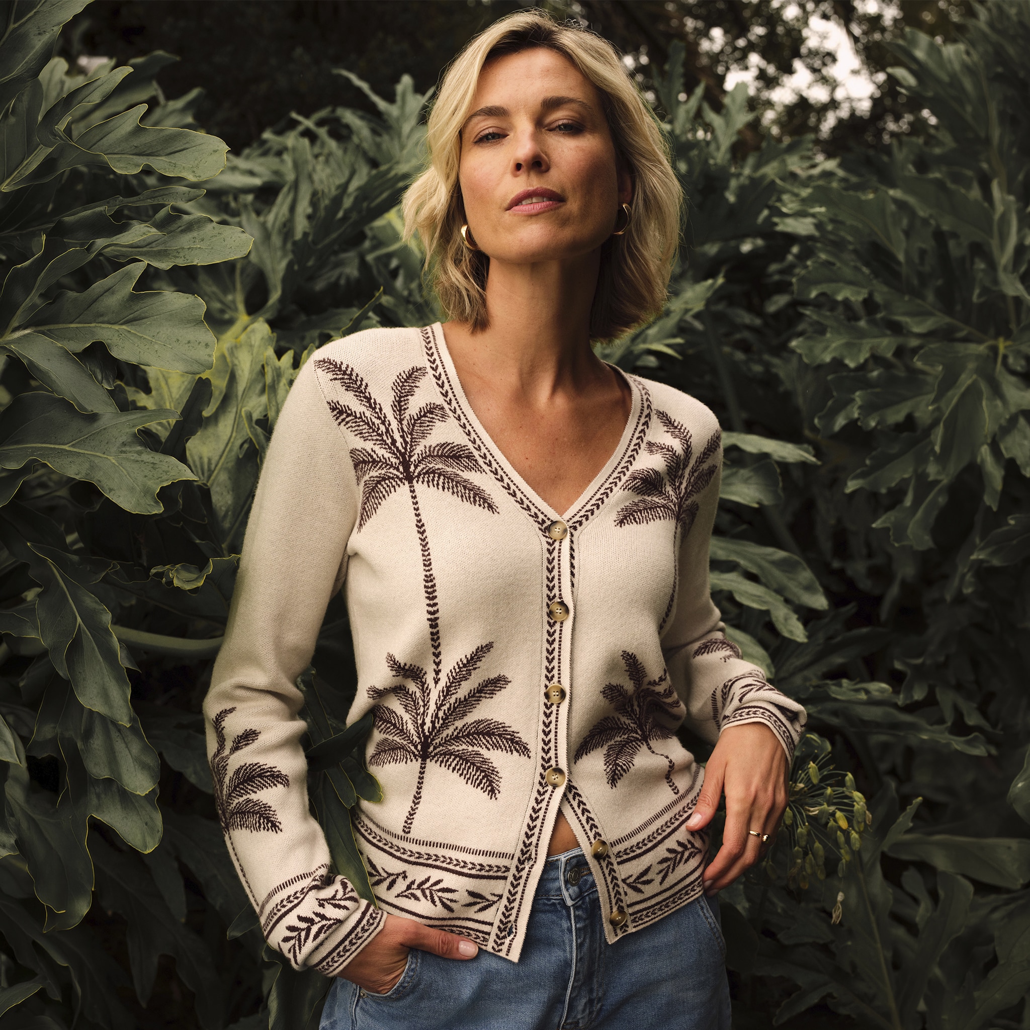A lady wearing a beige and brown floral patterned cardigan