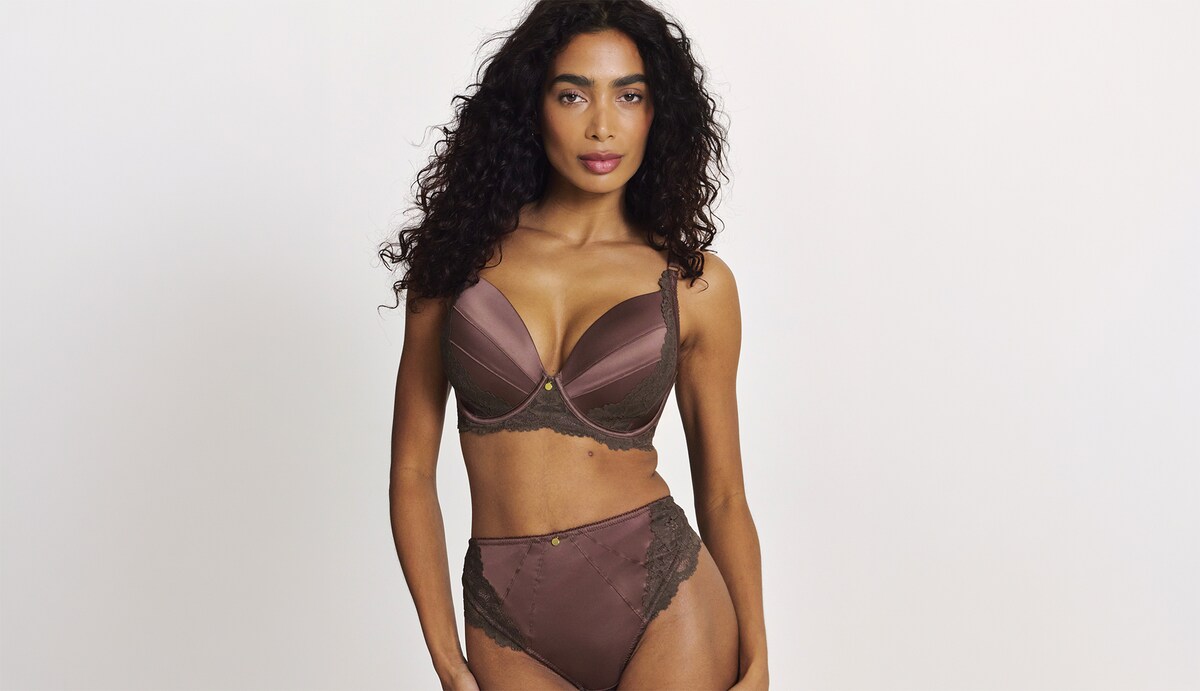 A woman wearing a brown silky matching lingerie set.