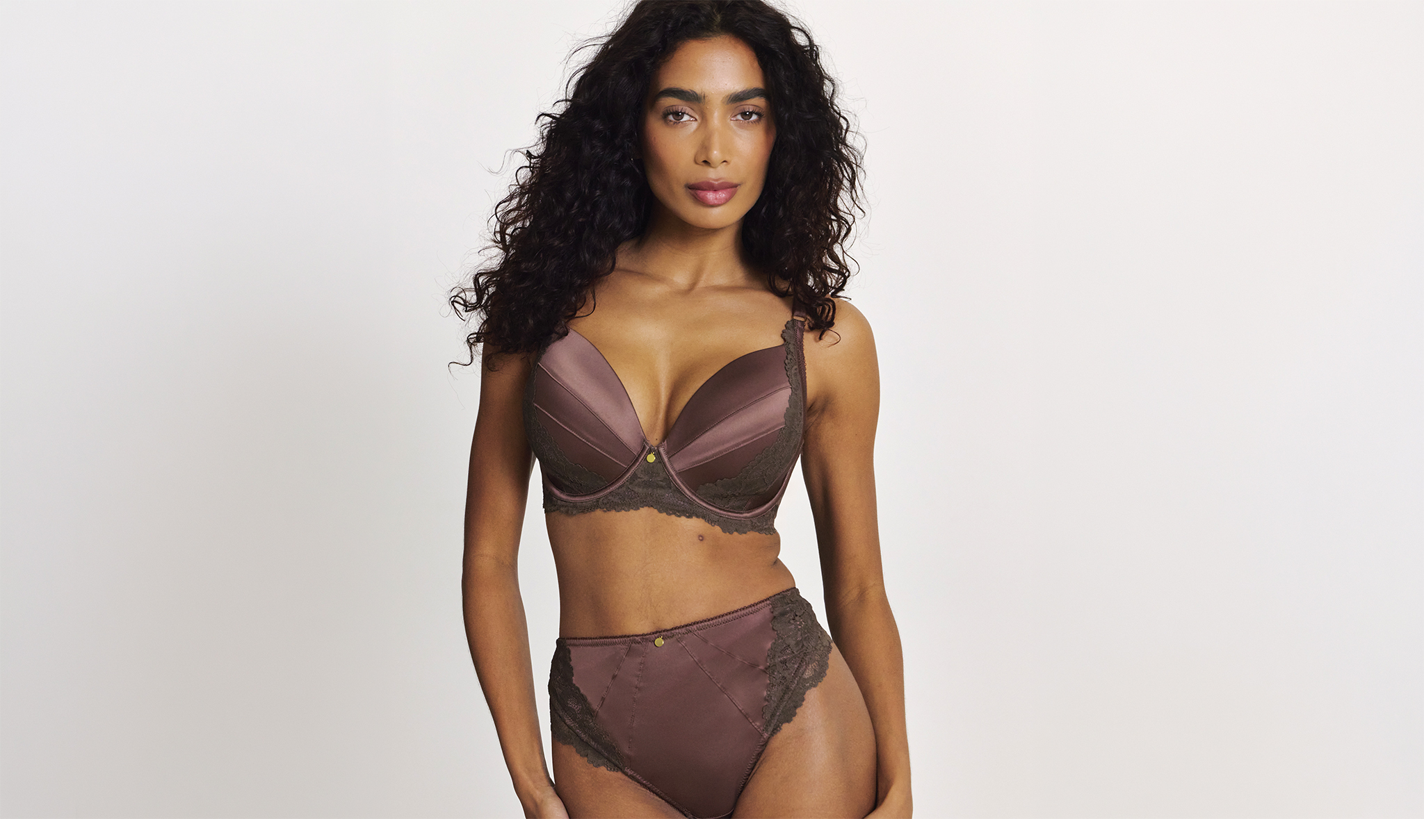 A woman wearing a brown silky matching lingerie set.