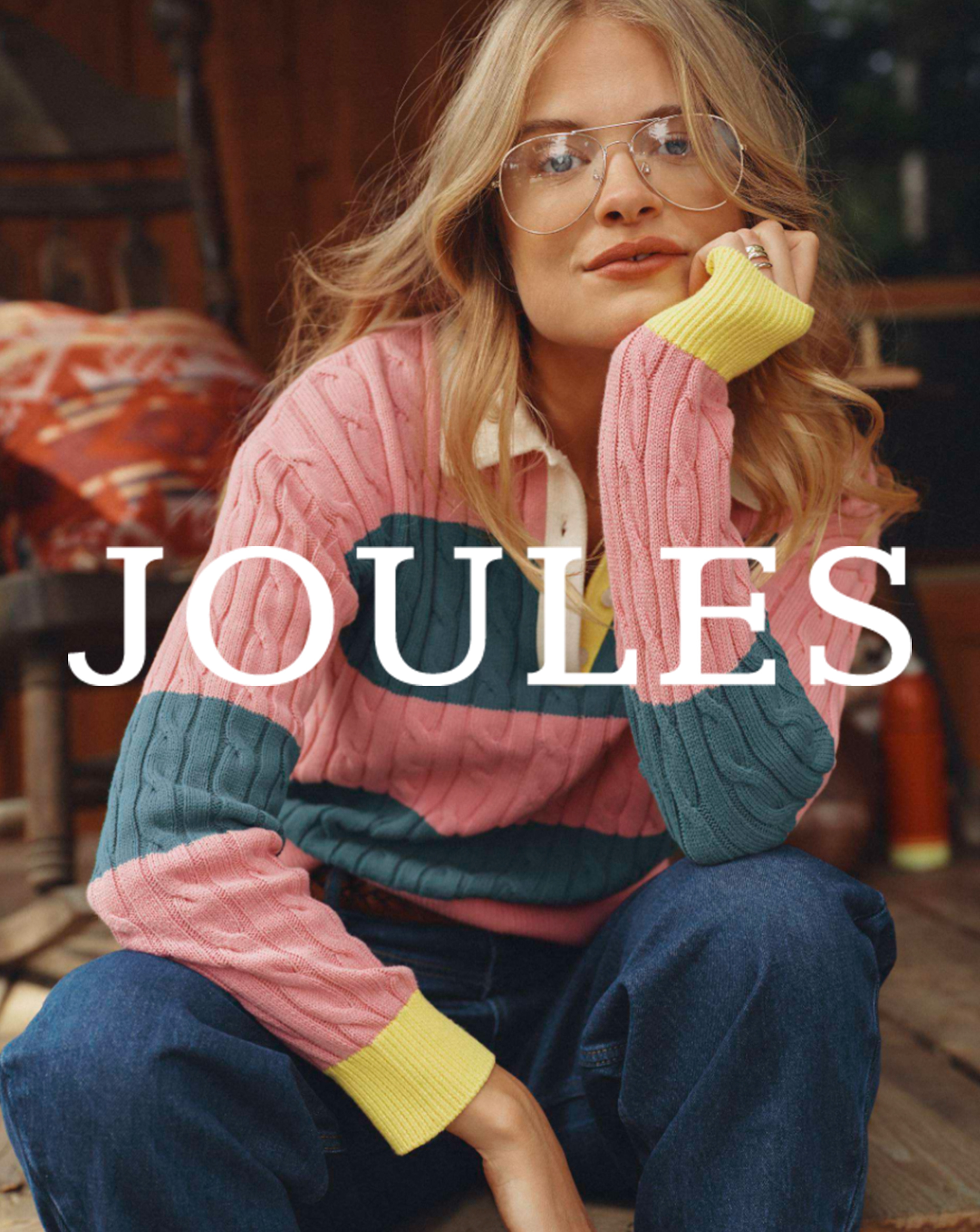 A woman wearing a colourful knitted Joules jumper.