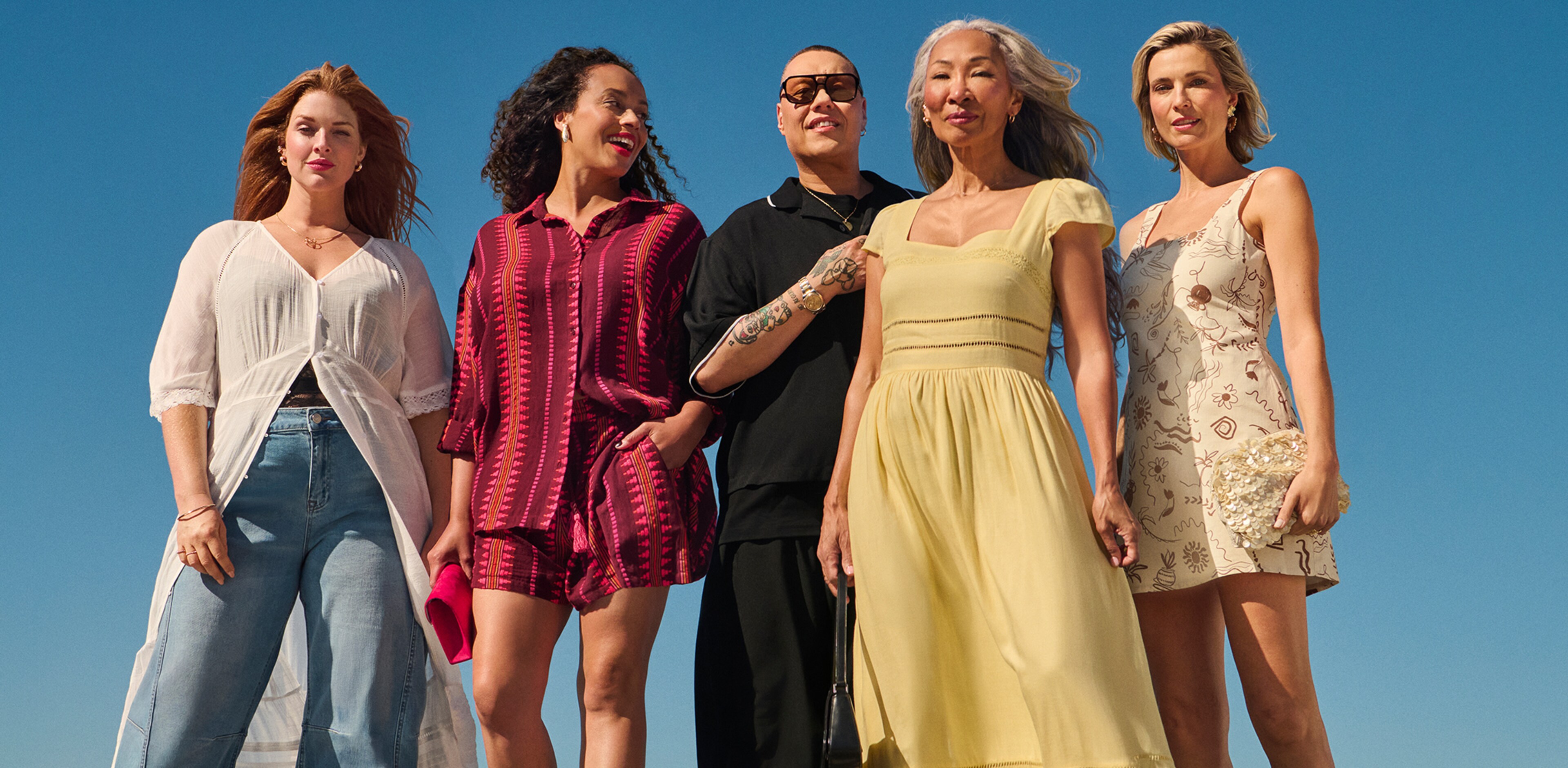 4 ladies and Gok Wan stood wearing holiday clothing. We see you.