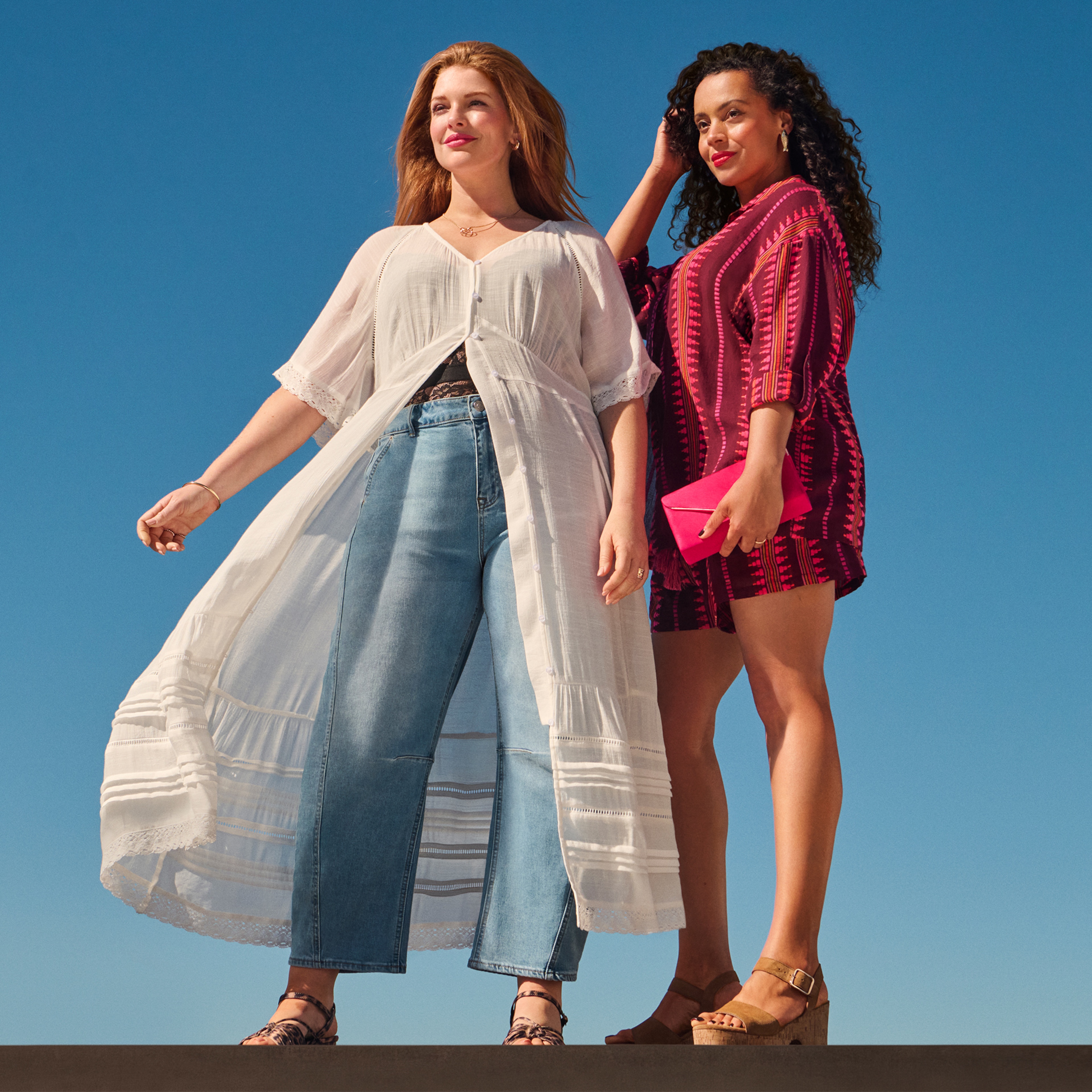 Two ladies stood looking to the left wearing summer clothing