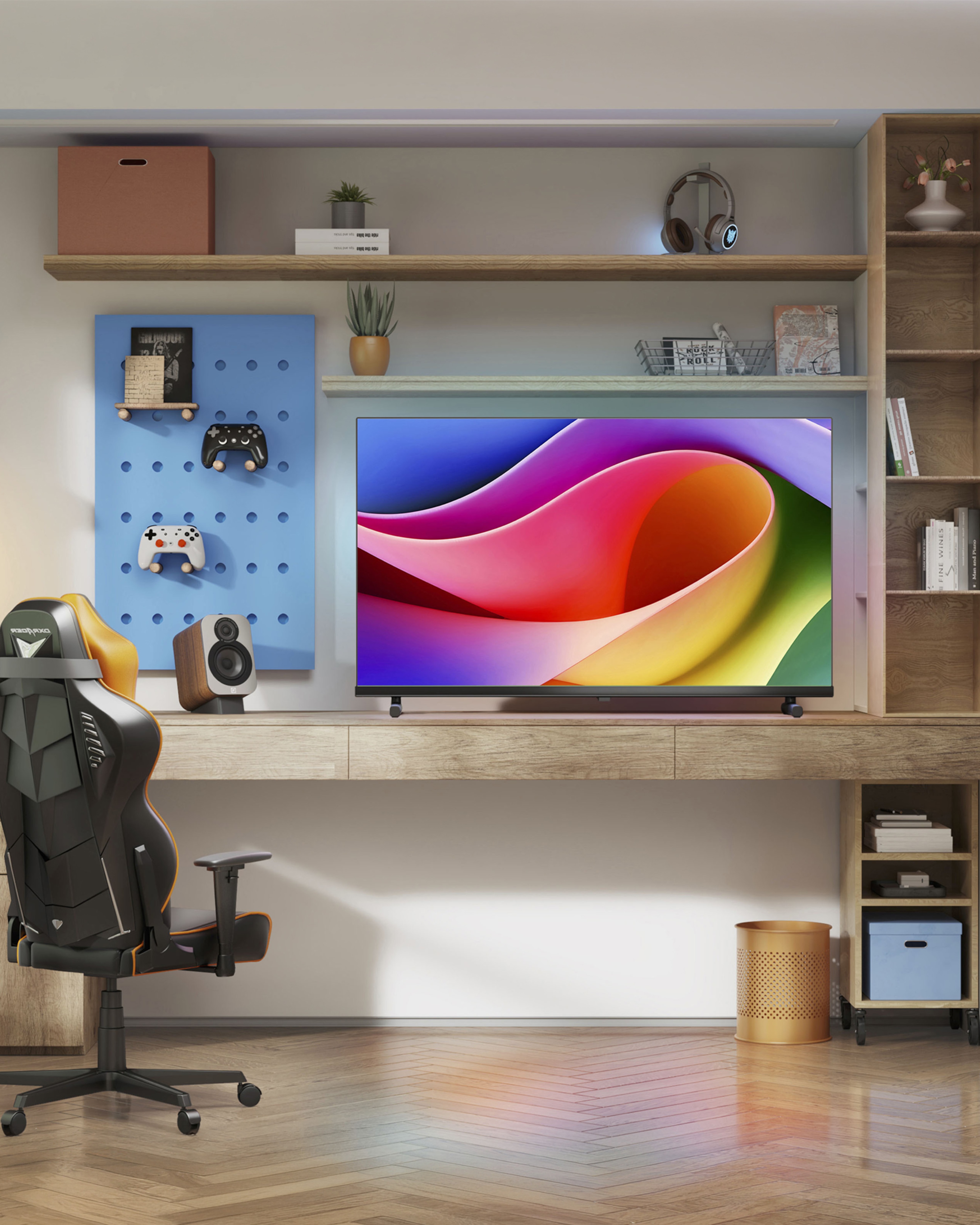 A room with various tech on a desk next to a wall. A tv, headphones, speaker and game controllers mounted on the wall or on the desk.
