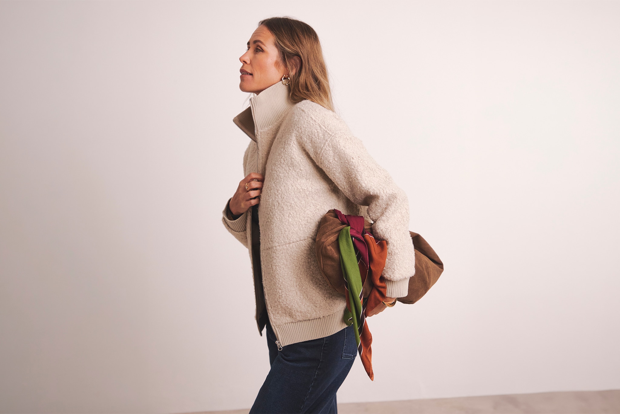 A woman wearing a cream borg fleece jacket.