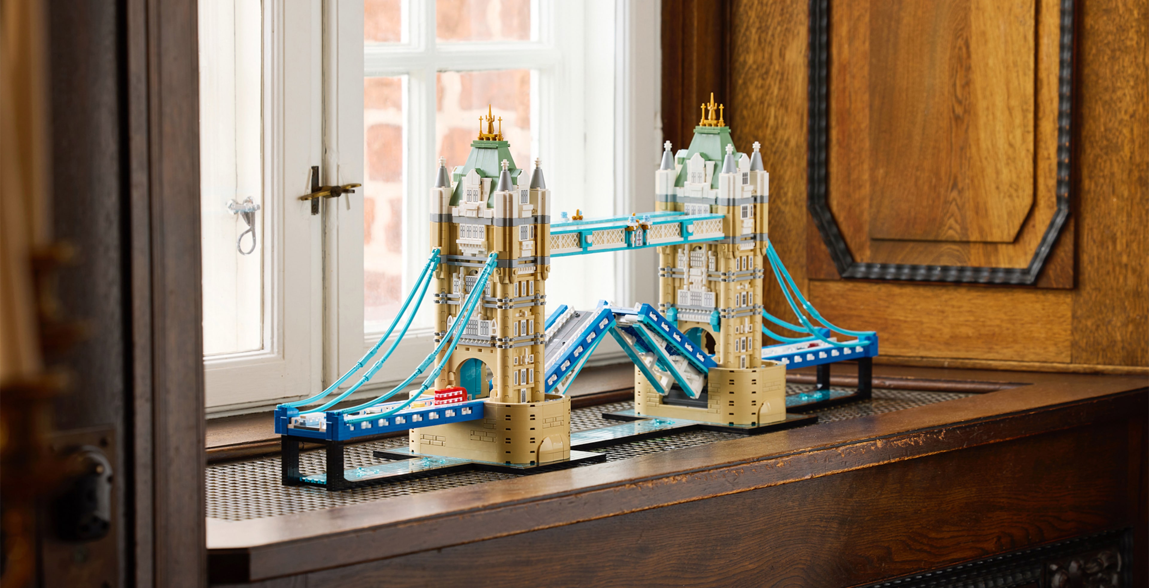 A LEGO® tower bridge model on a wooden window sil
