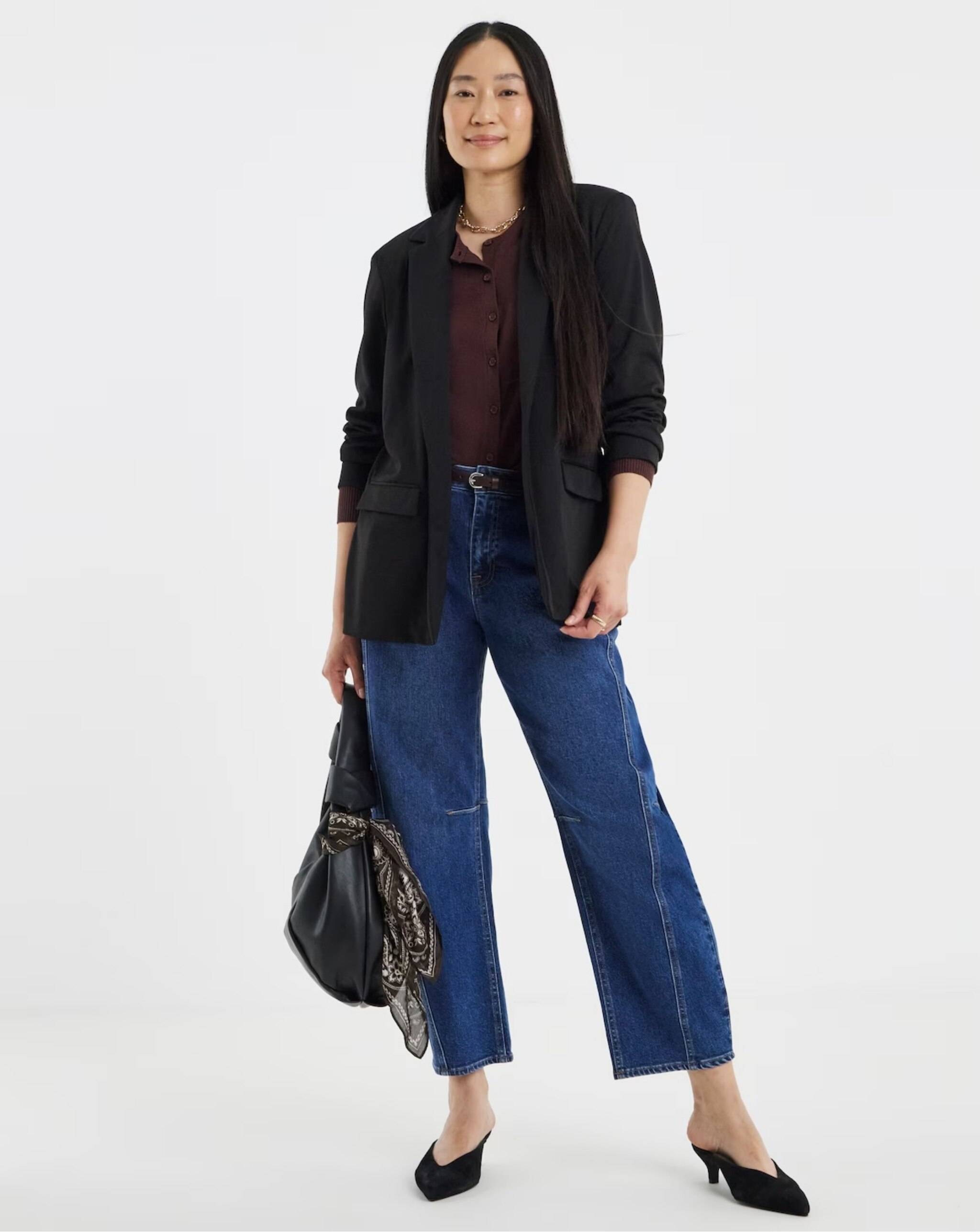 Woman wearing black blazer and denim jeans