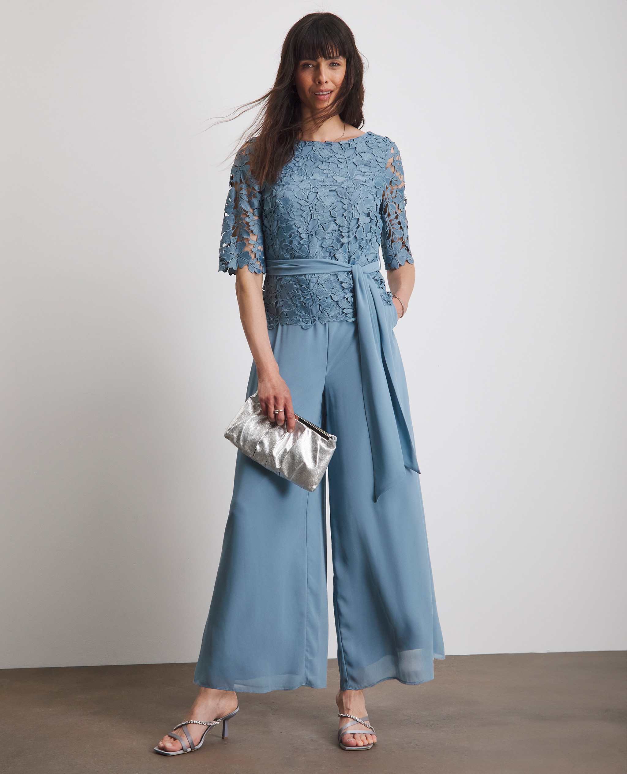 Model wears Joanna Hope Lace Jumpsuit in Blue