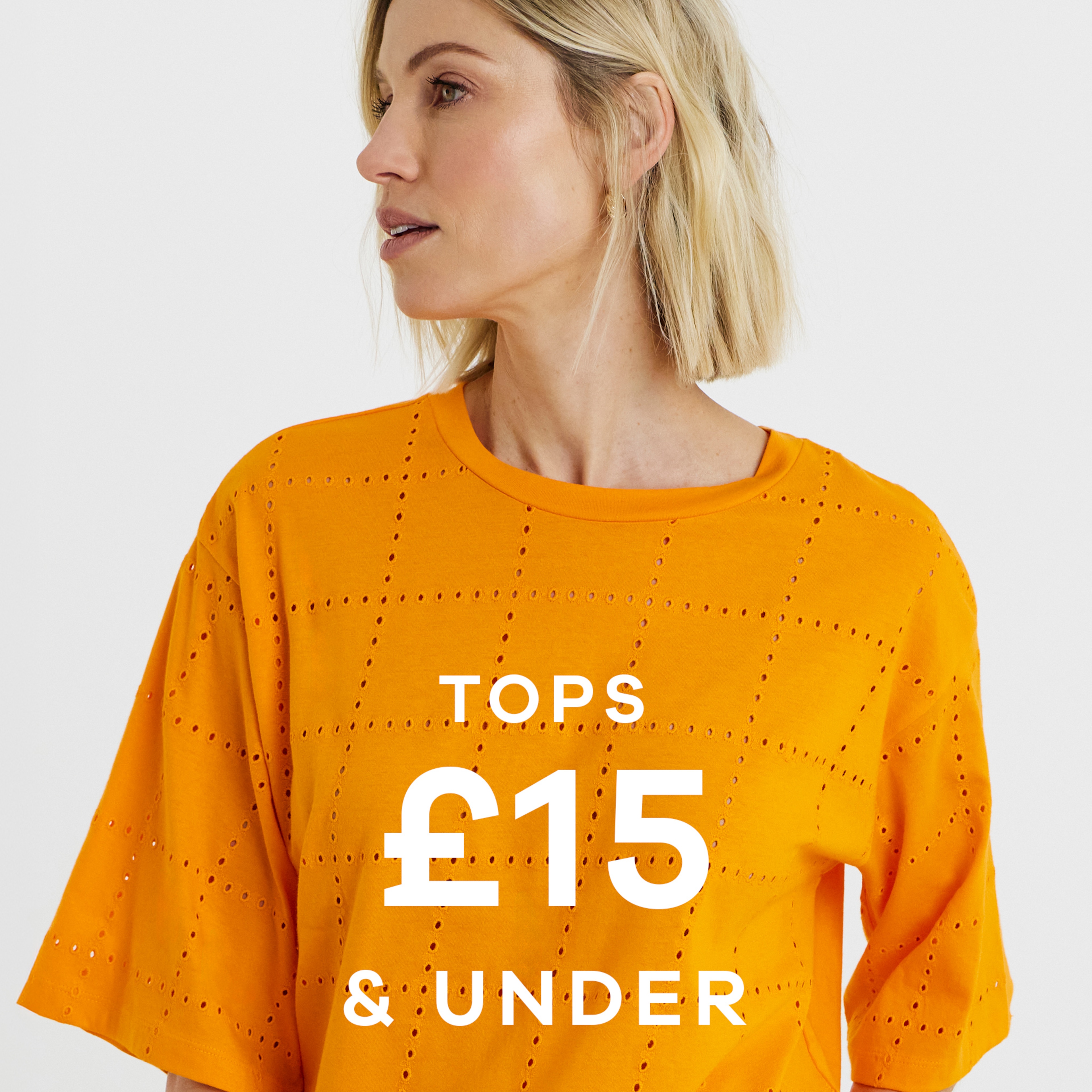 A woman wearing an orange top looking to the left. Tops £15 and under.