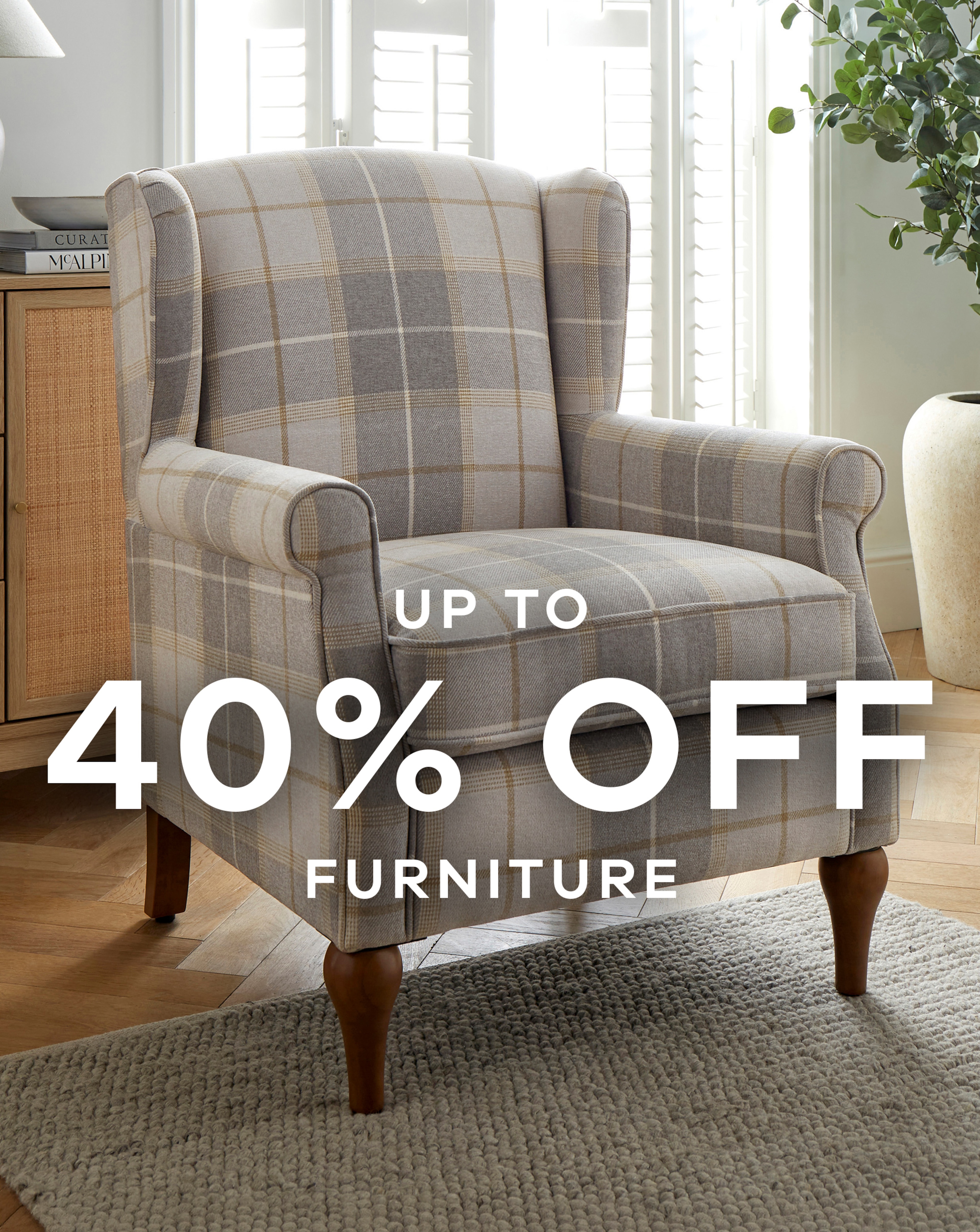 A pale brown and grey check patterend arm chair.
