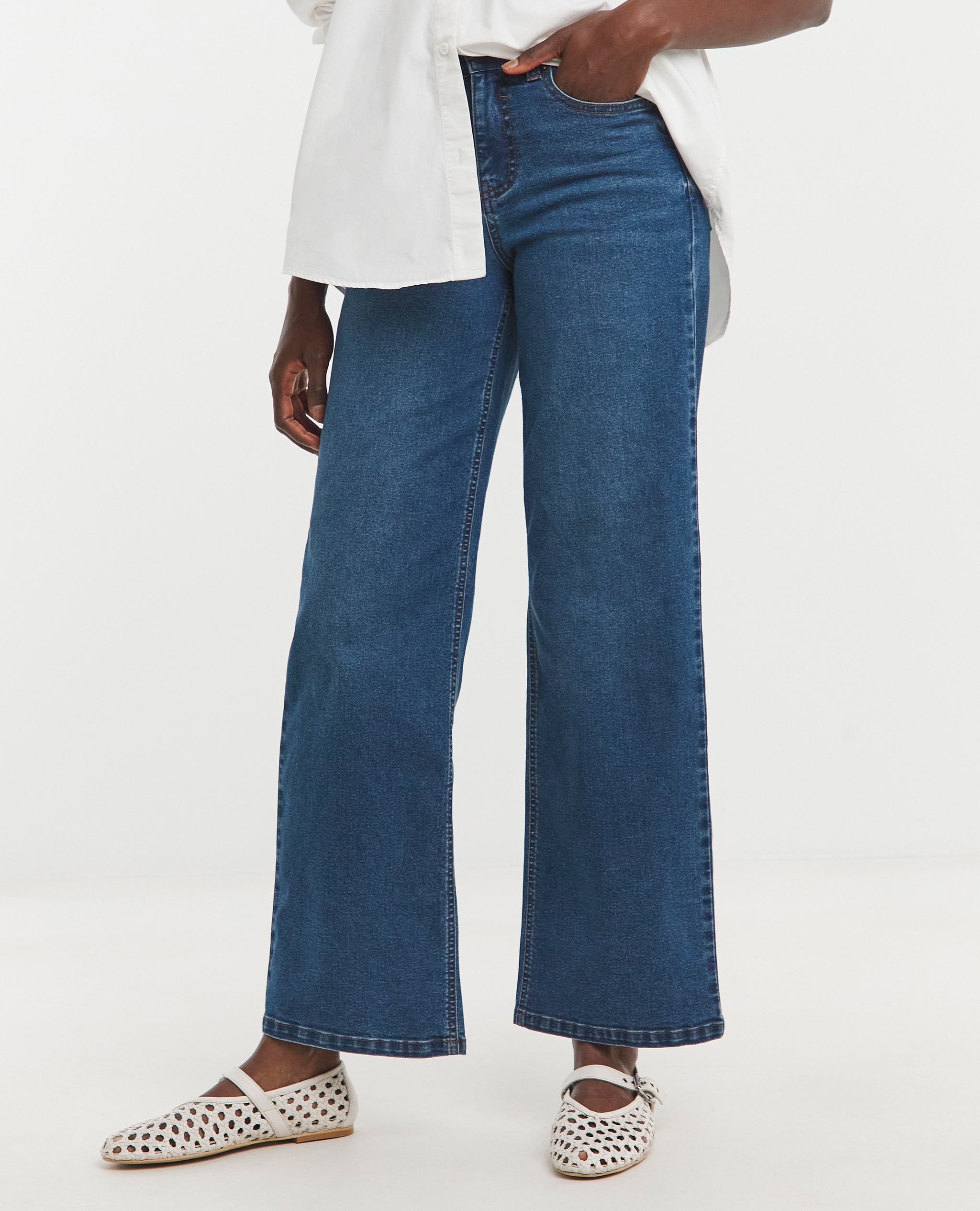 Wide Leg. Model wears 24/7 Blue Wide Leg Jeans
