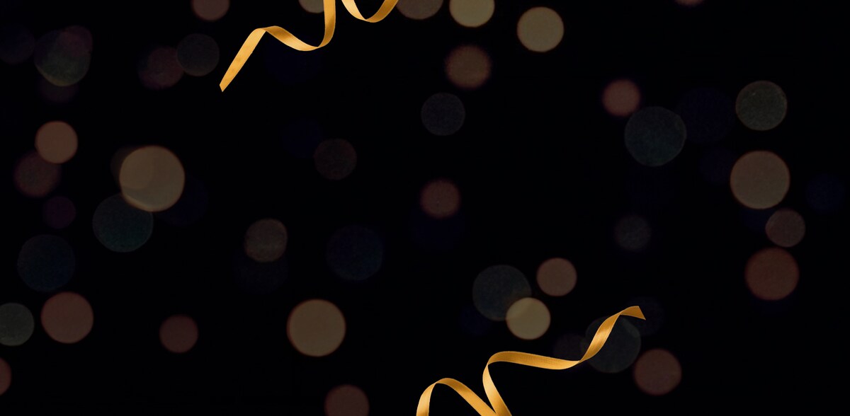Black glittery background with gold ribbons on.