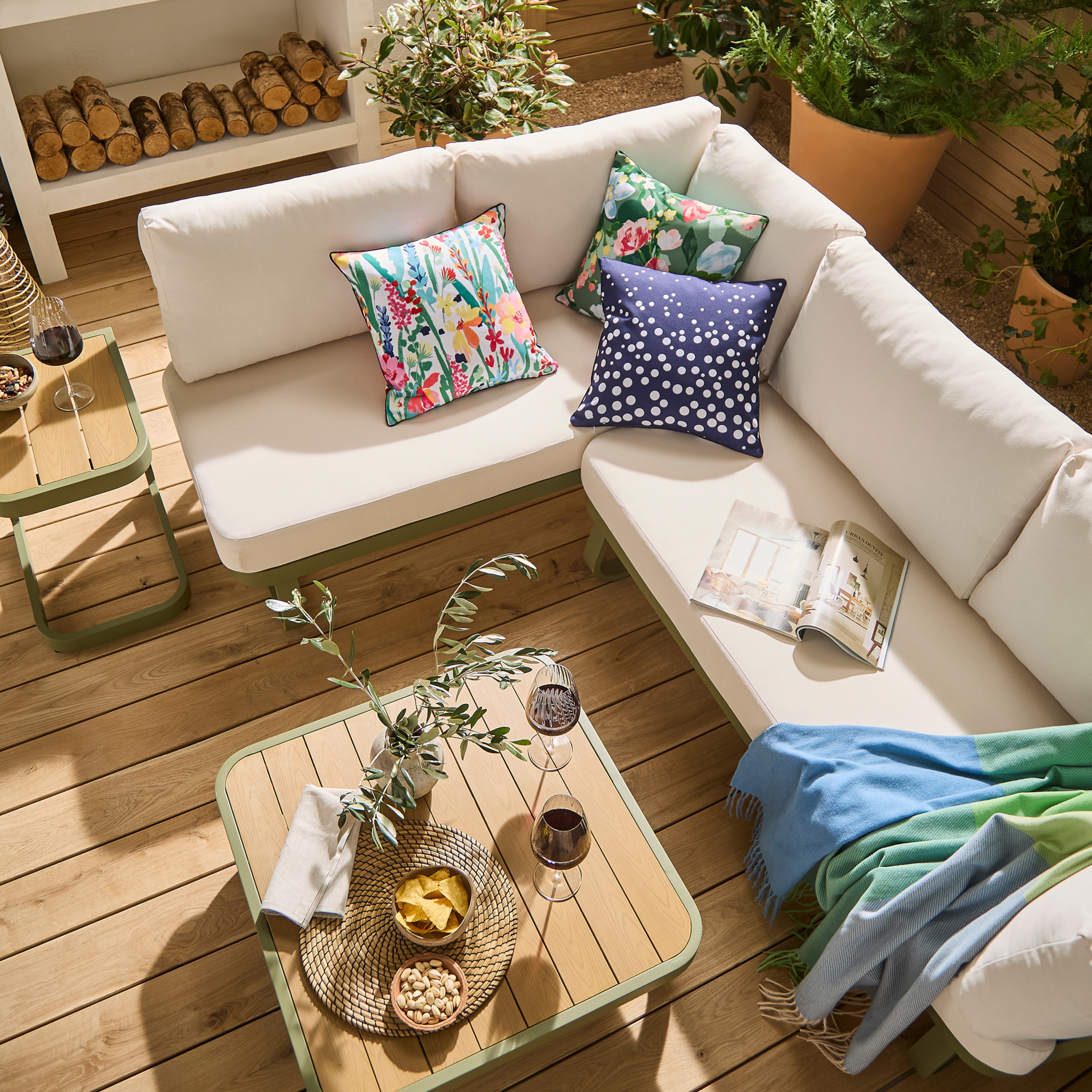 A small garden view with an L shaped beige corner sofa.