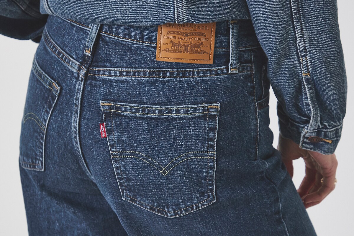 Model wears Levi's High Rise Wide Leg in Mid Wash