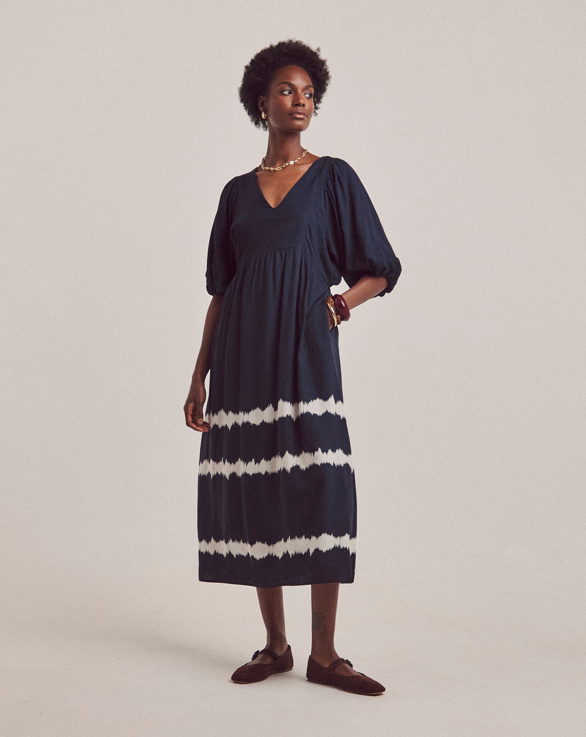 A woman wearing a blue and white patterened dress
