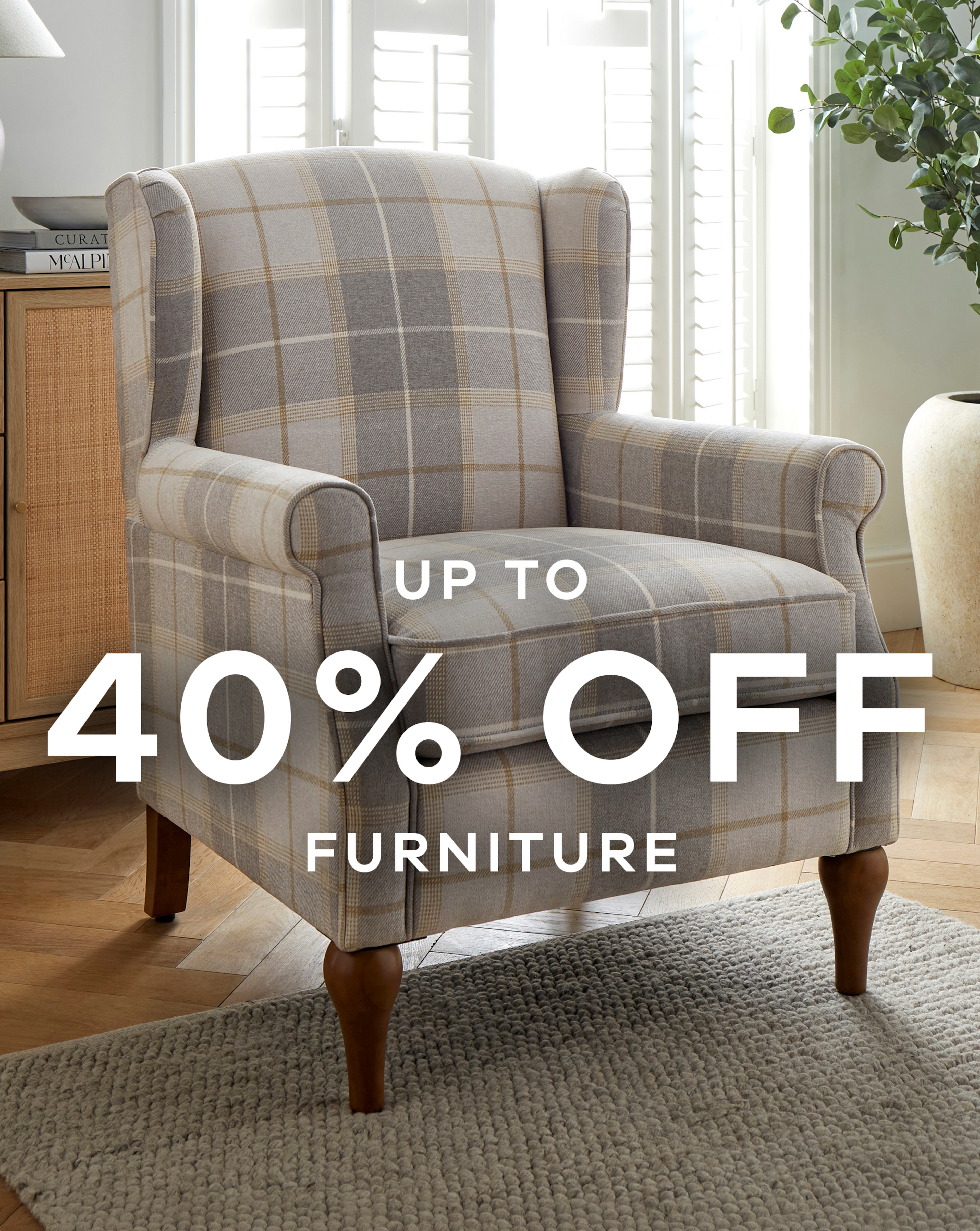 A pale brown and grey check patterend arm chair.
