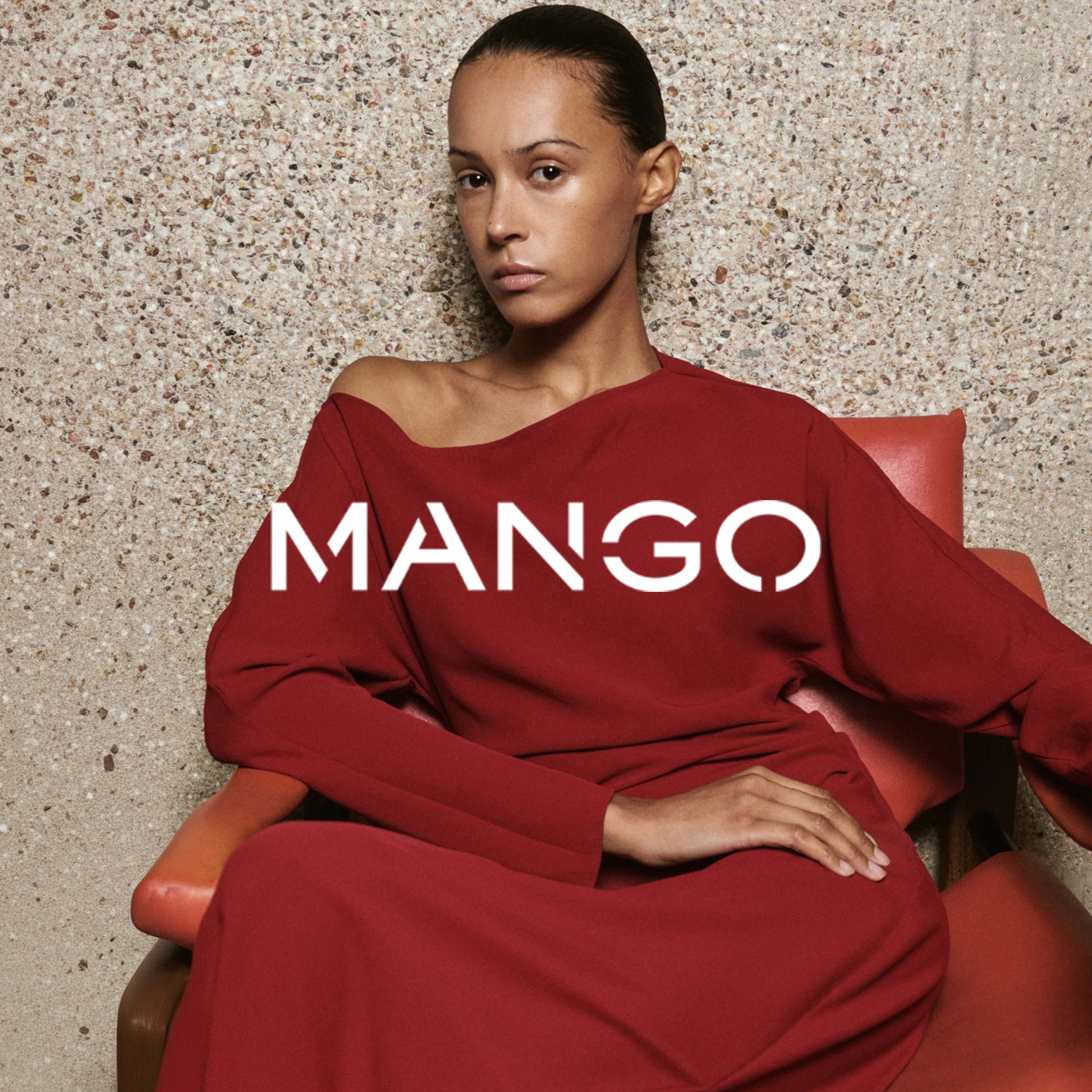 A lady sat in a chair wearing a red Mango dress.