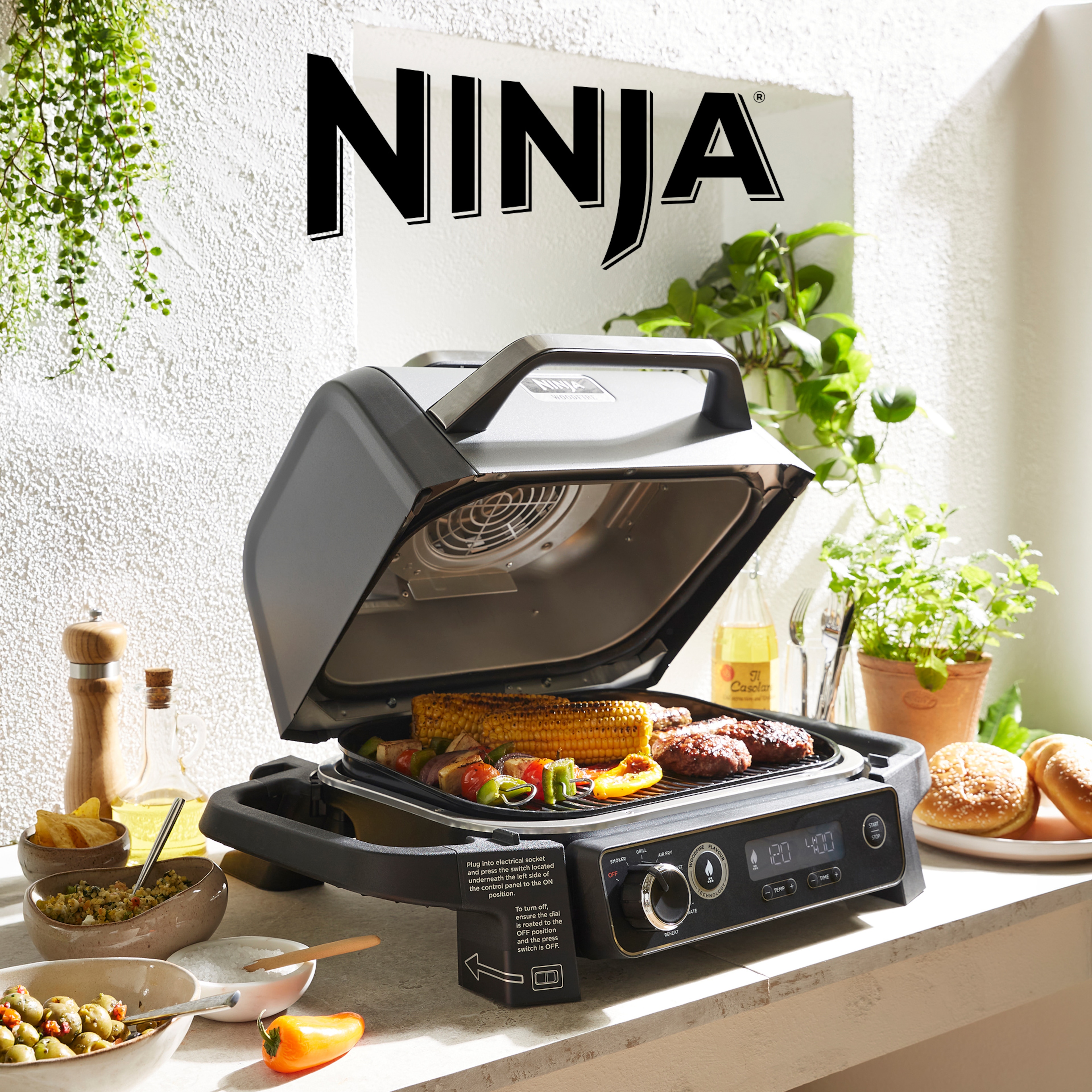 A Ninja cooking appliance on a table outside.