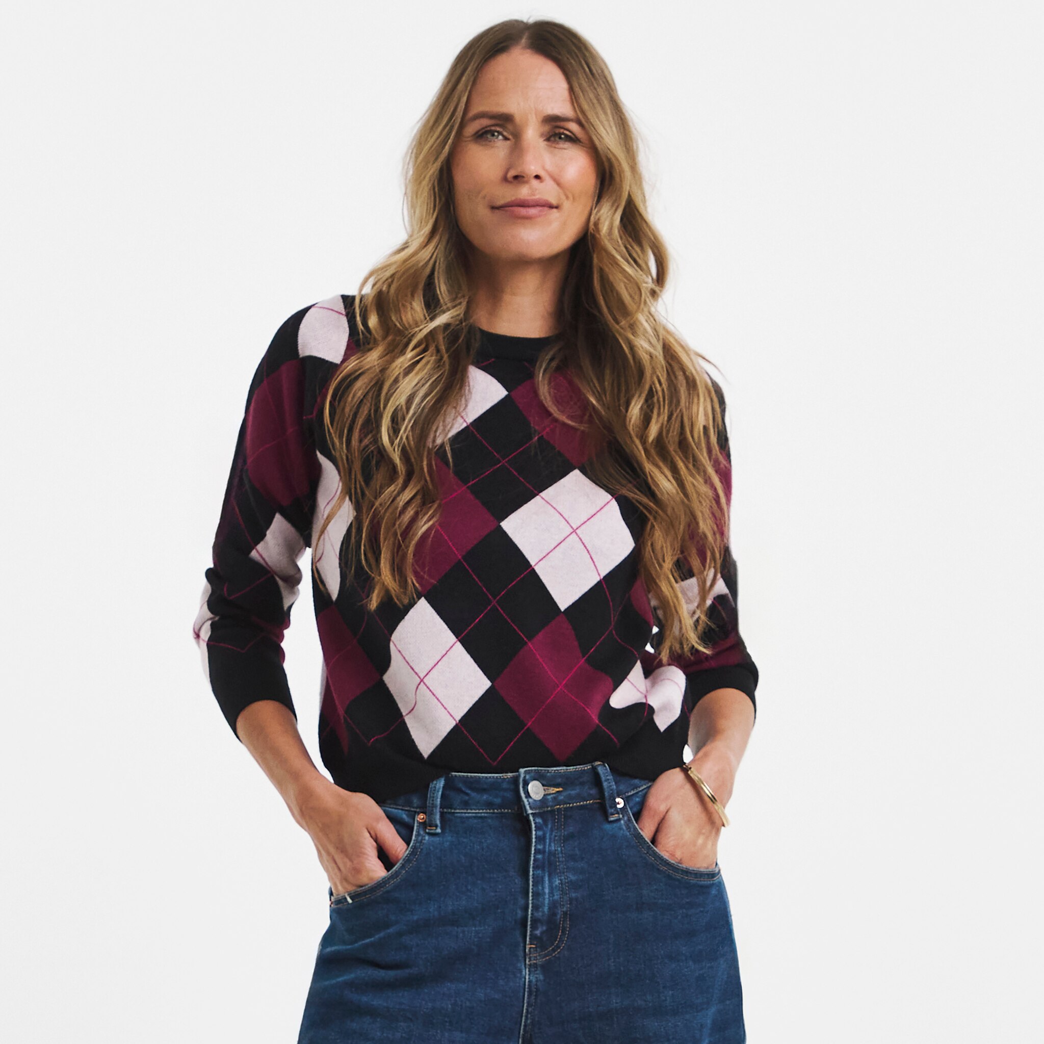 A woman wearing a black check argyle jumper.