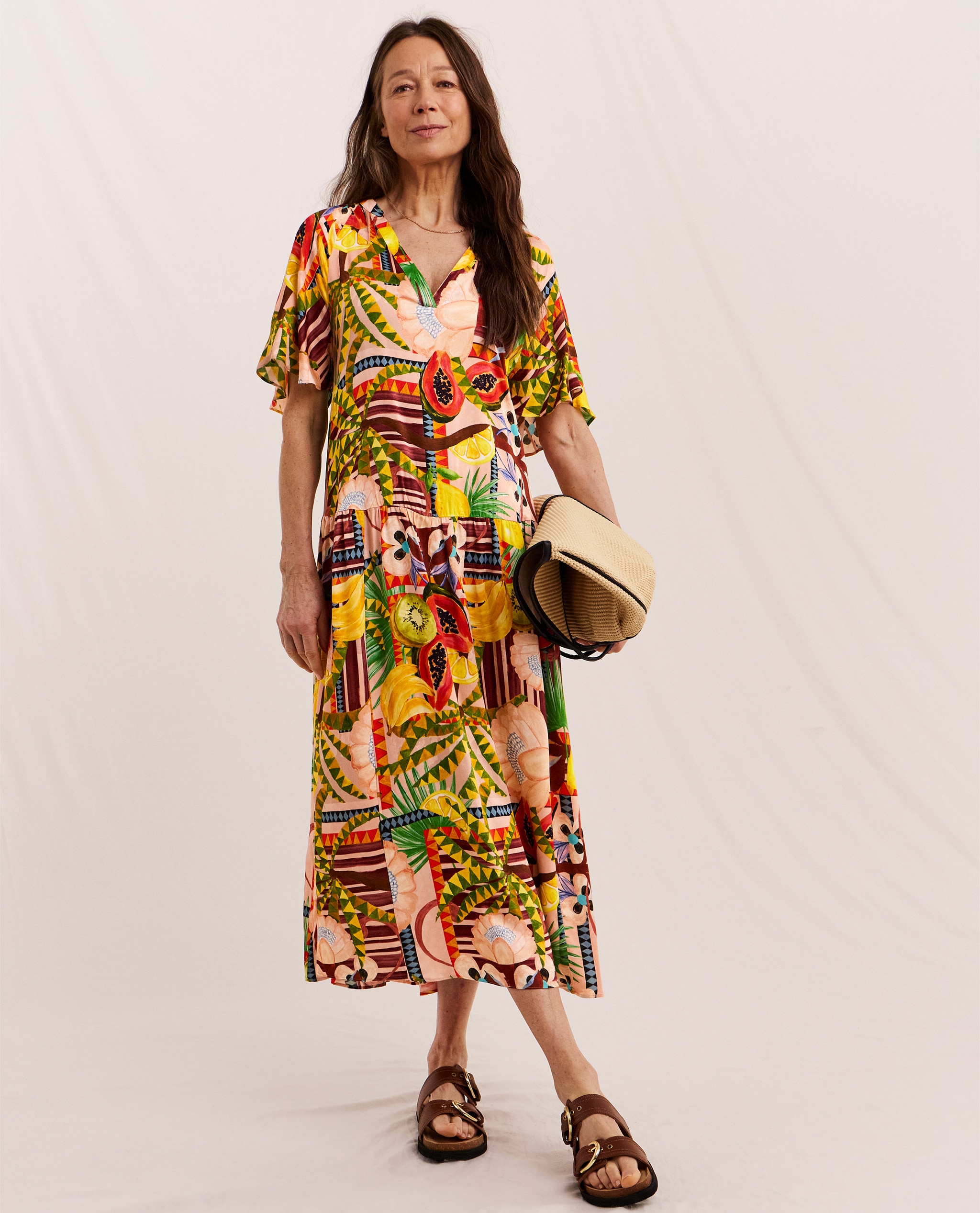 Model wears multi-coloured print dress