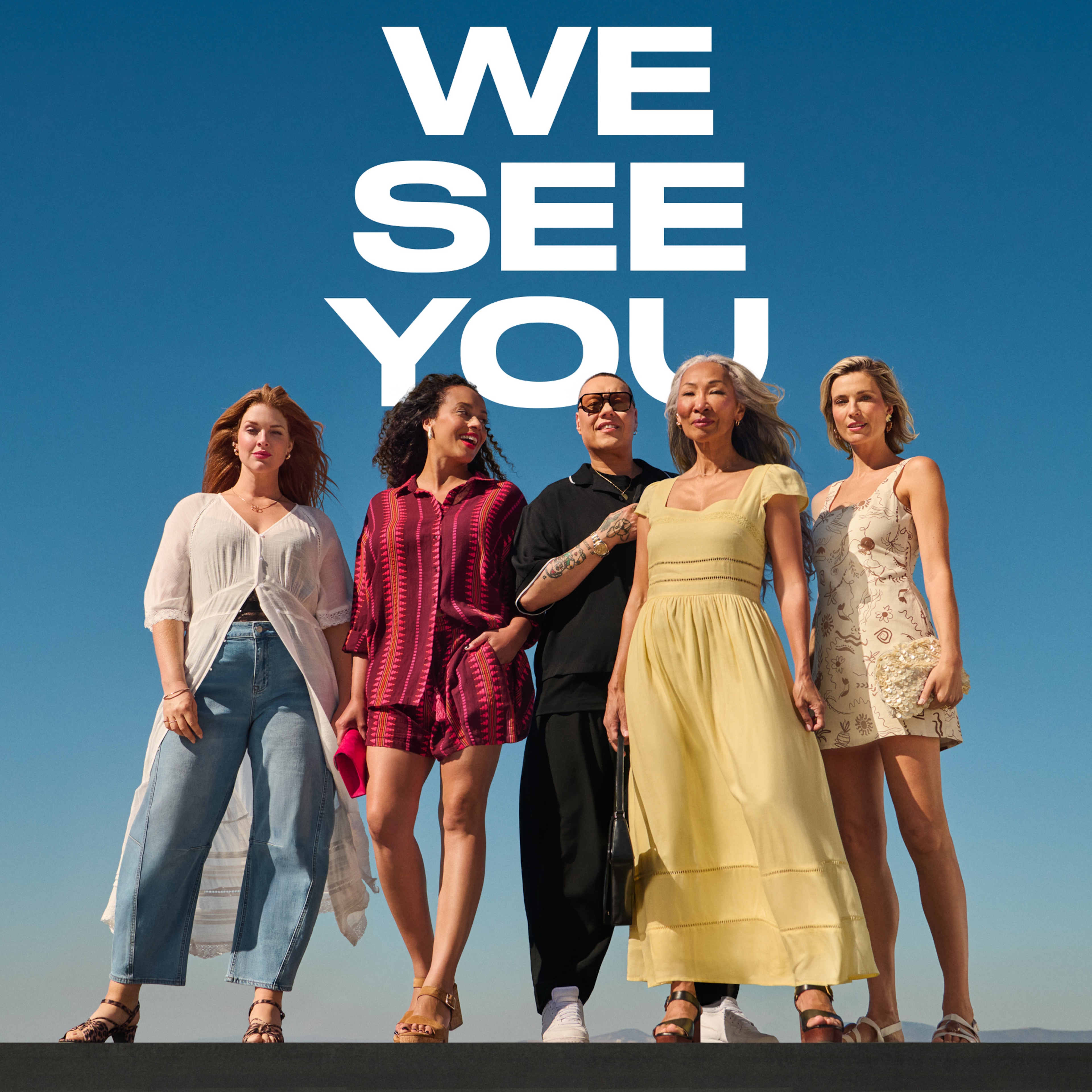 4 ladies and Gok Wan stood outside on a sunny day with deep blue sky behind them.