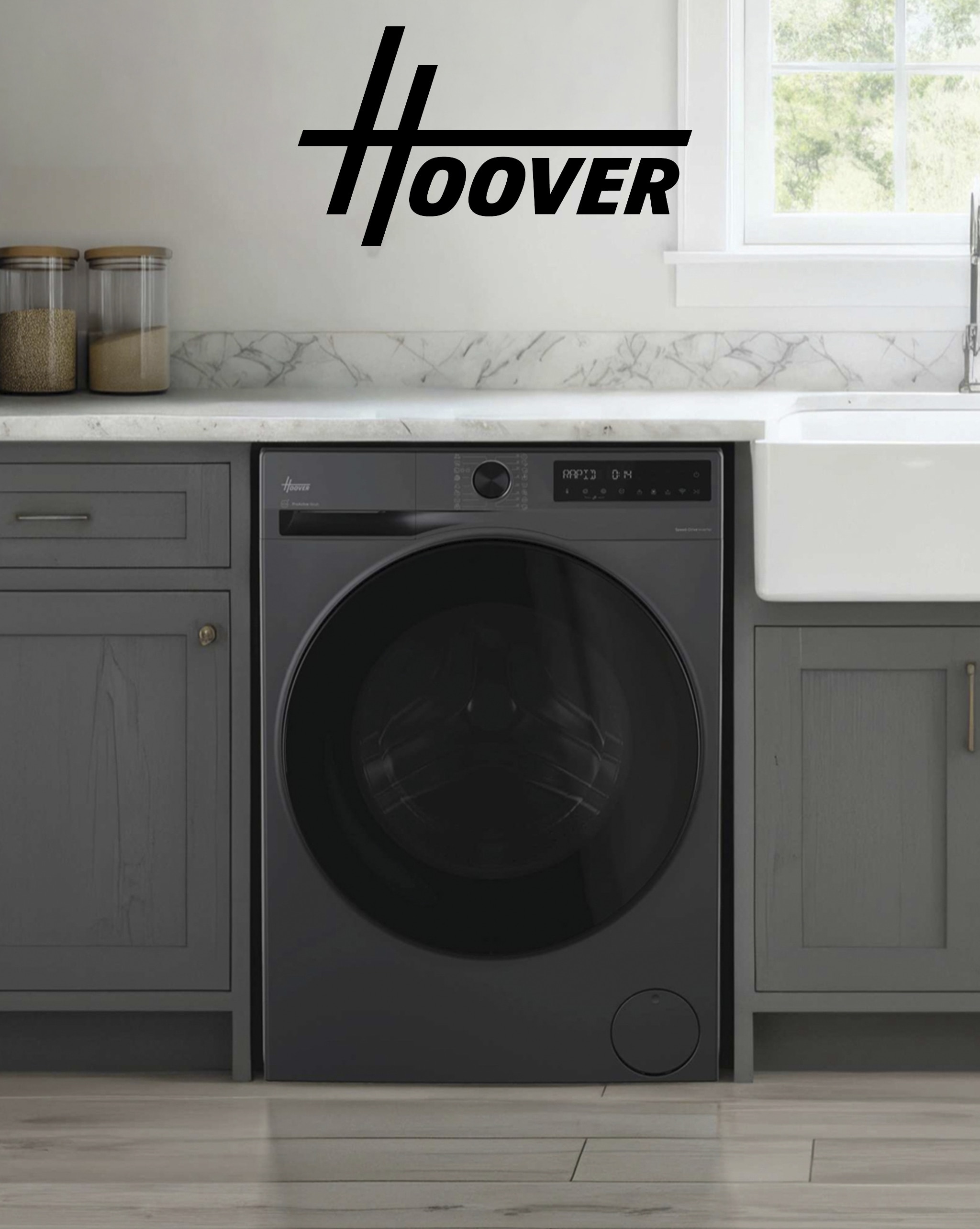 A dark grey Hoover washing appliance under a kitchen work top.