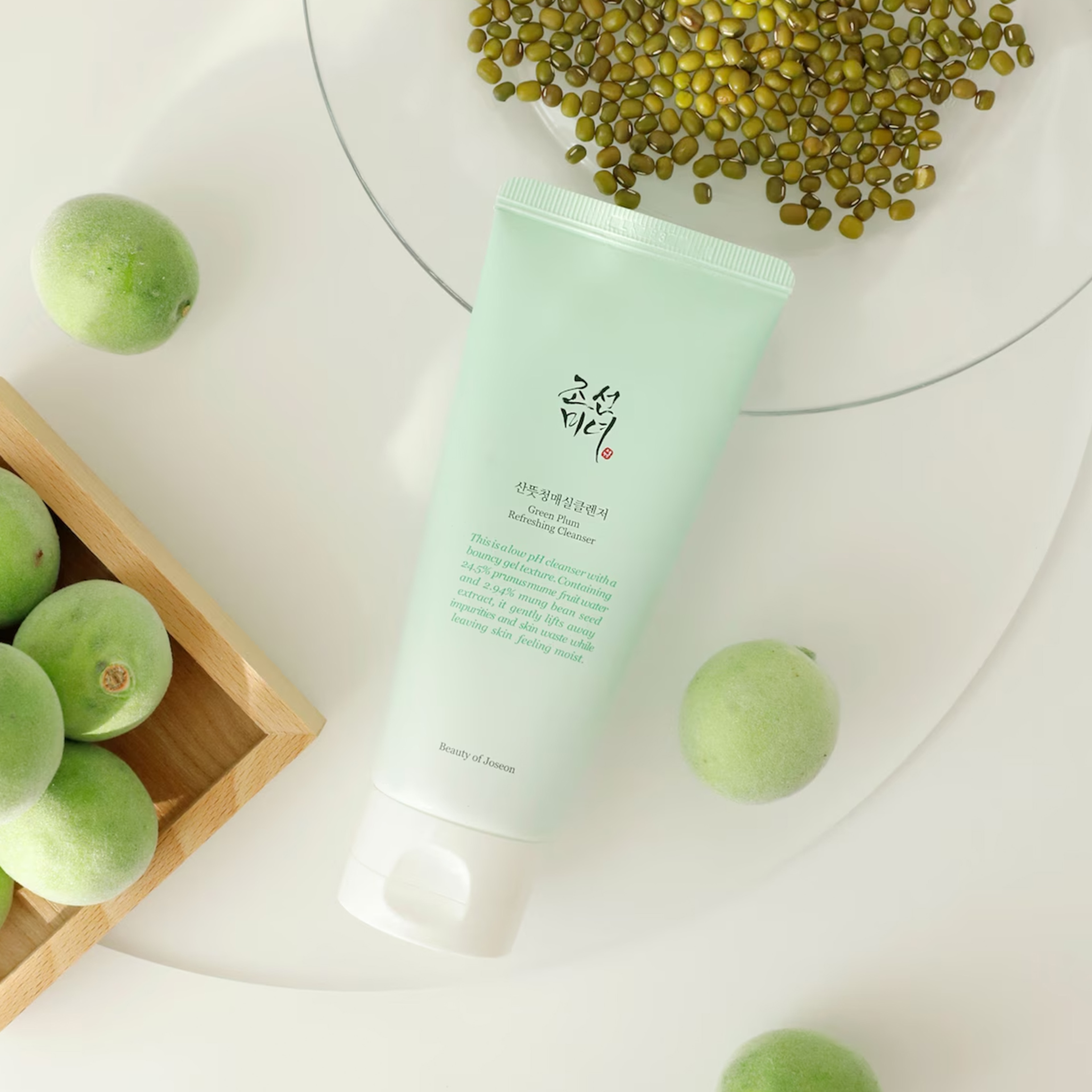 A green packaged beauty product on a table.