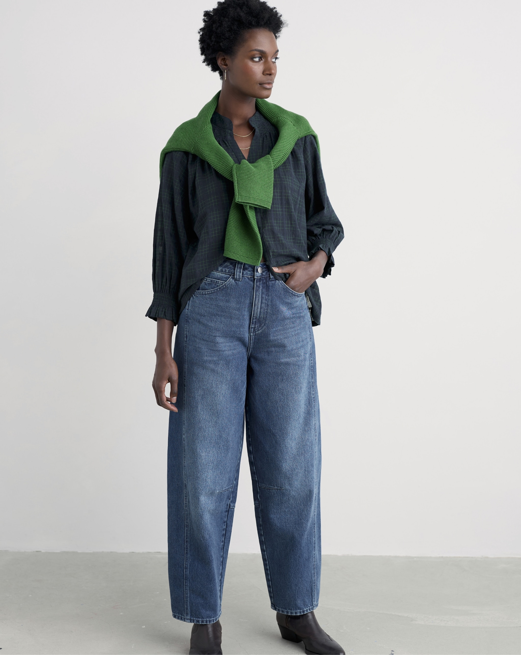 Woman wearing navy shirt and denim jeans