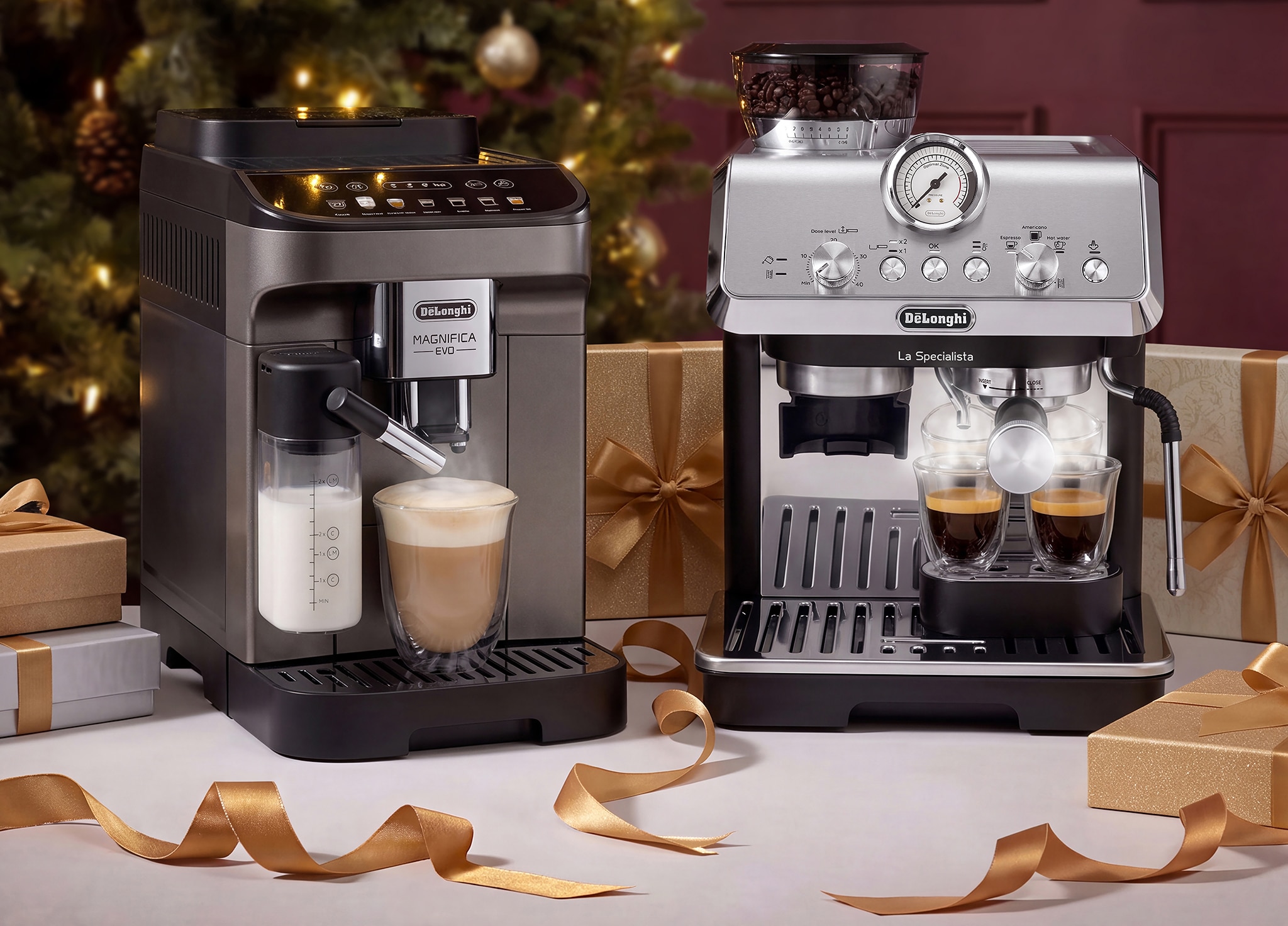 Two coffee machines on table surrounded by wrapped present boxes and ribbons on a table.