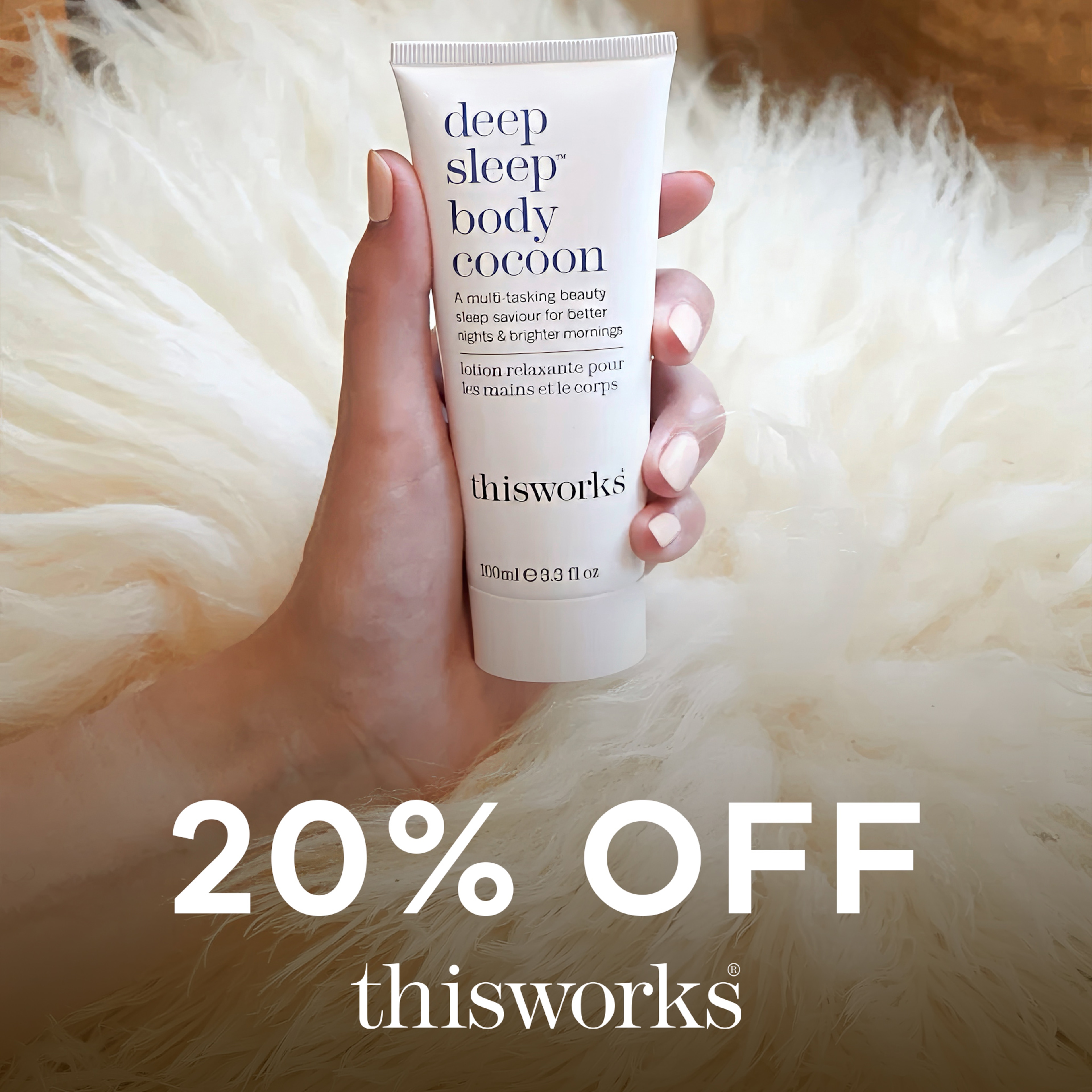 A hand holding a tube of Thisworks beauty product.