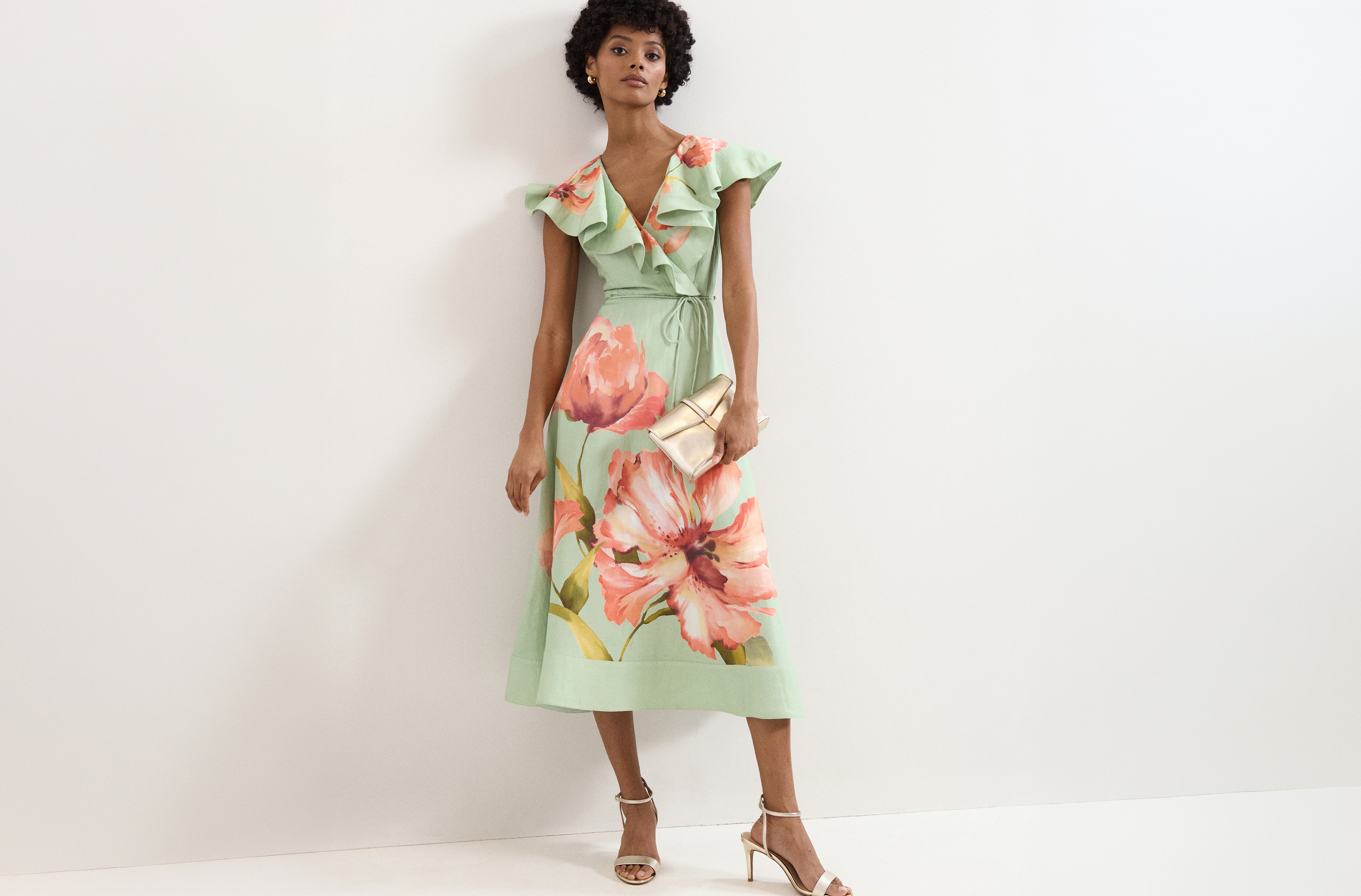 A woman wearing a green floral dress.