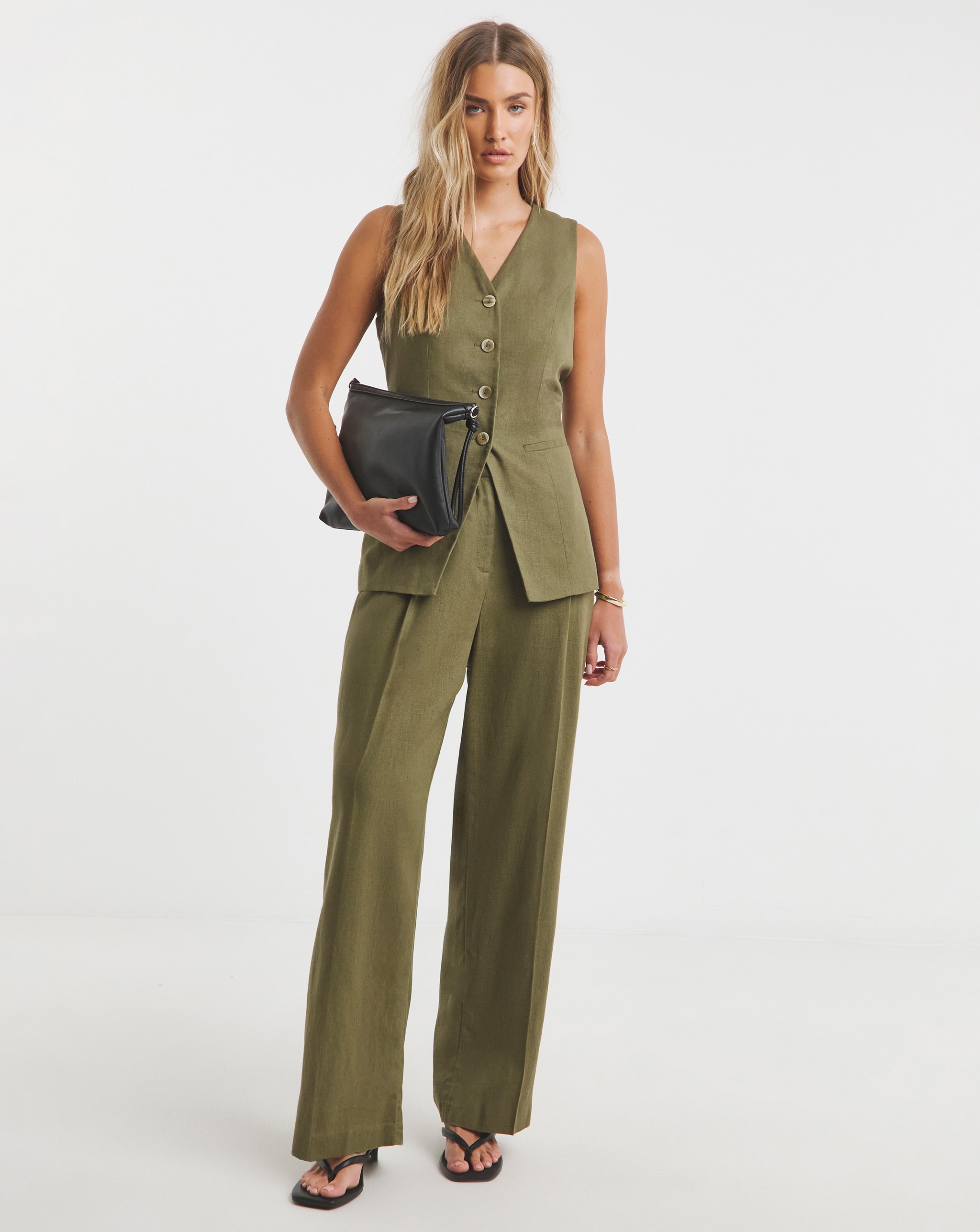 Person wearing a khaki-coloured linen waistcoat and trousers