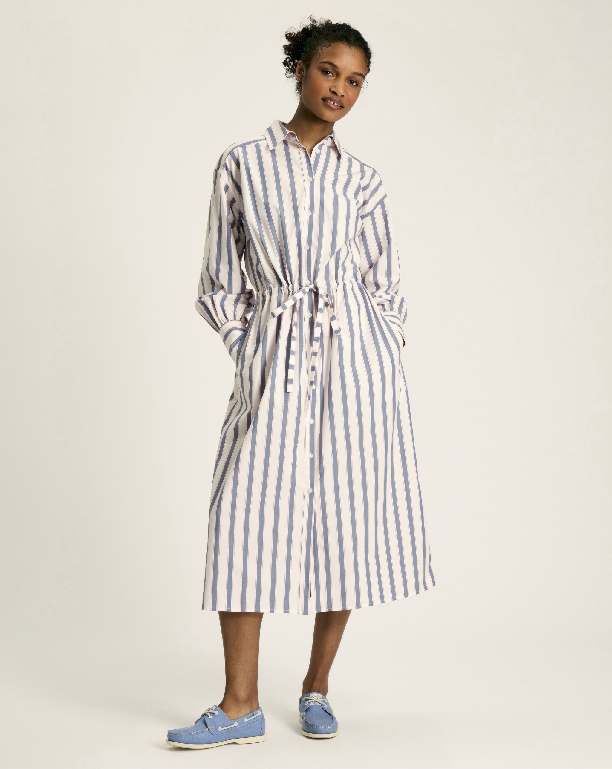Woman wearing blue and white striped dress