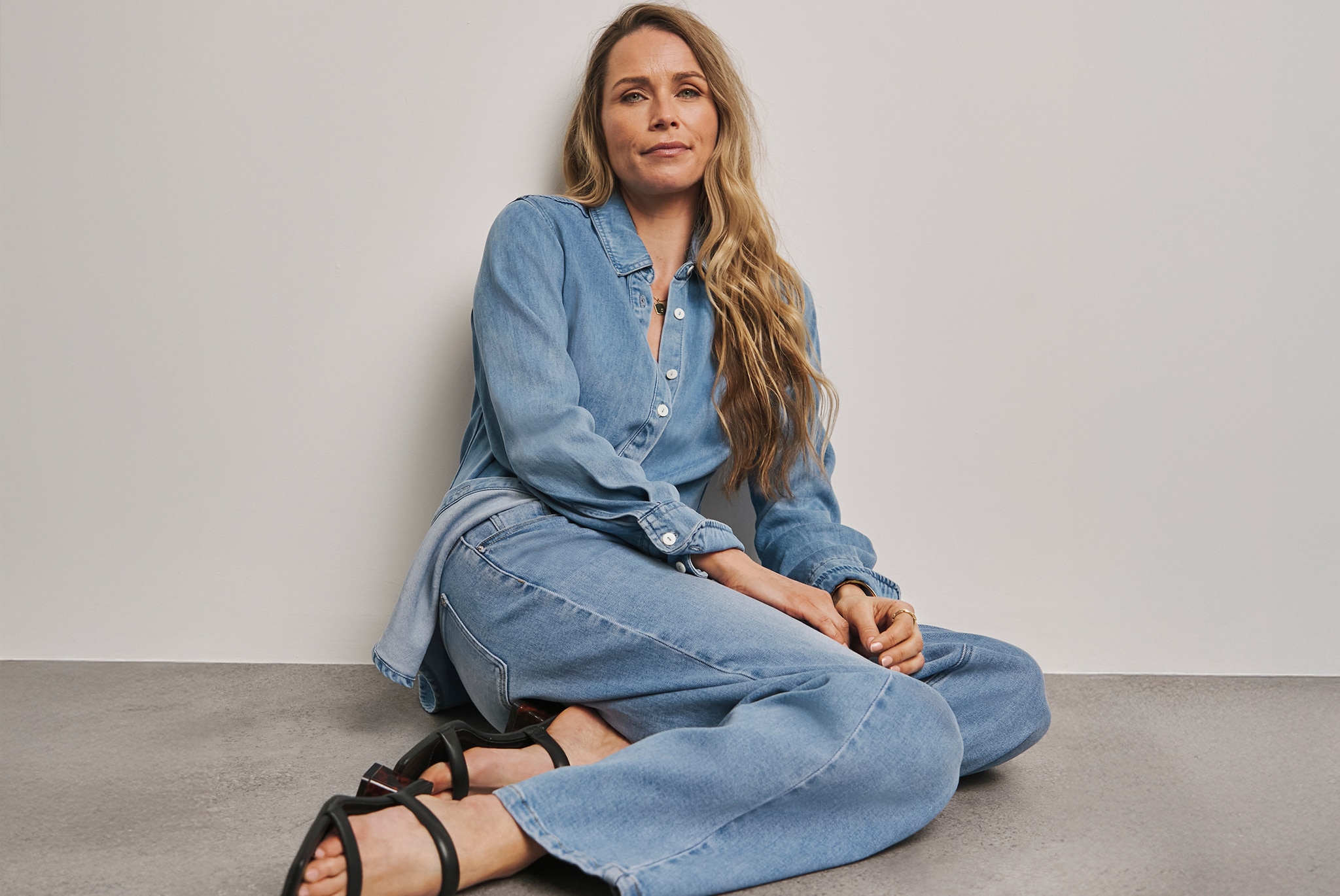 Model wears Anthology Light Blue Wide Leg Jeans in Light Wash
