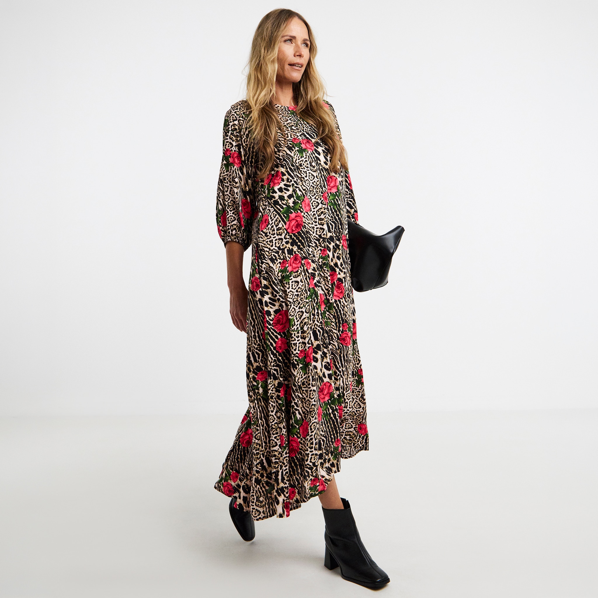 A woman wearing a floral and animal print maxi dress.