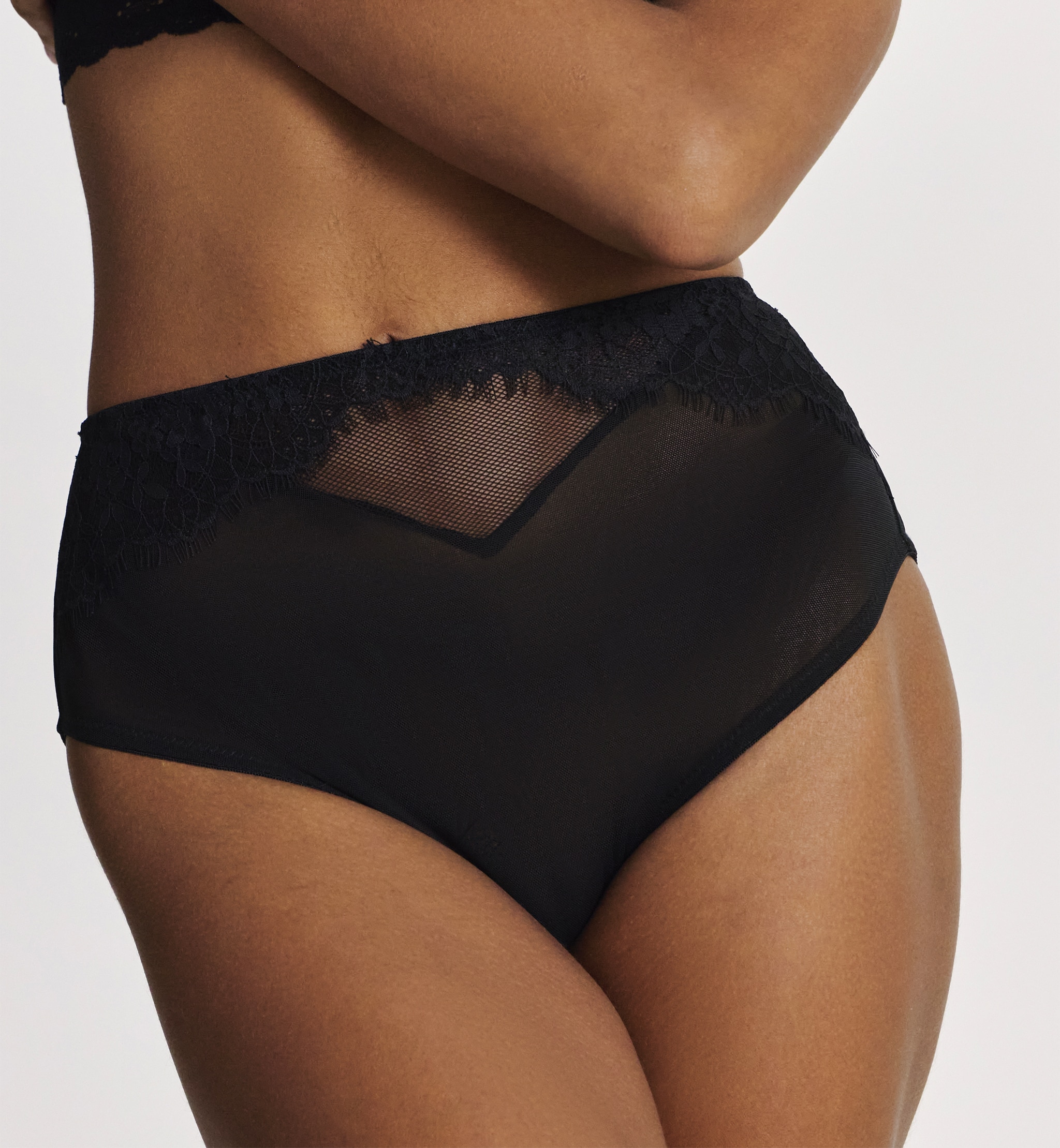 A woman wearing black knickers