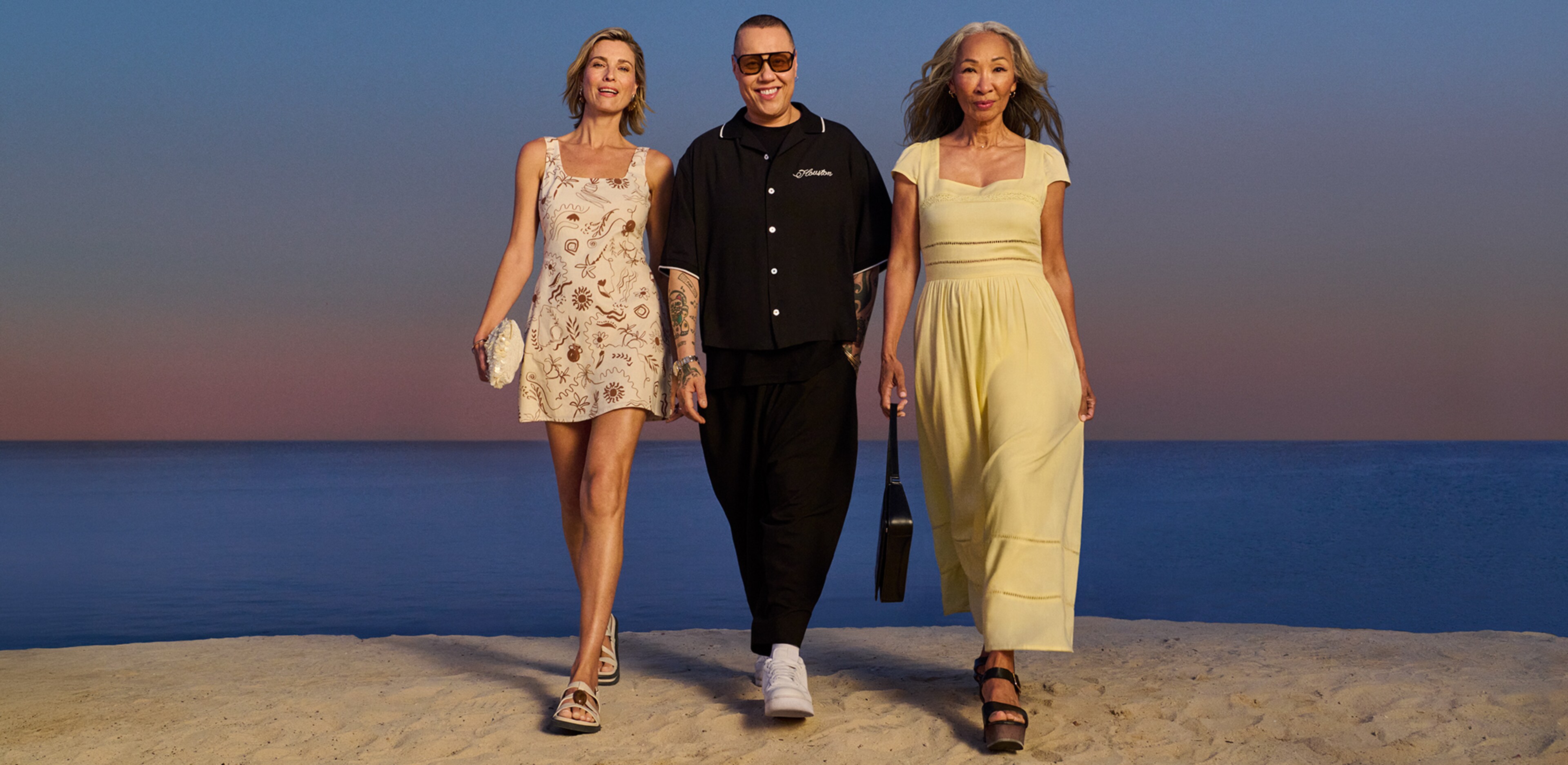 Gok Wan with two ladies walking either side of him