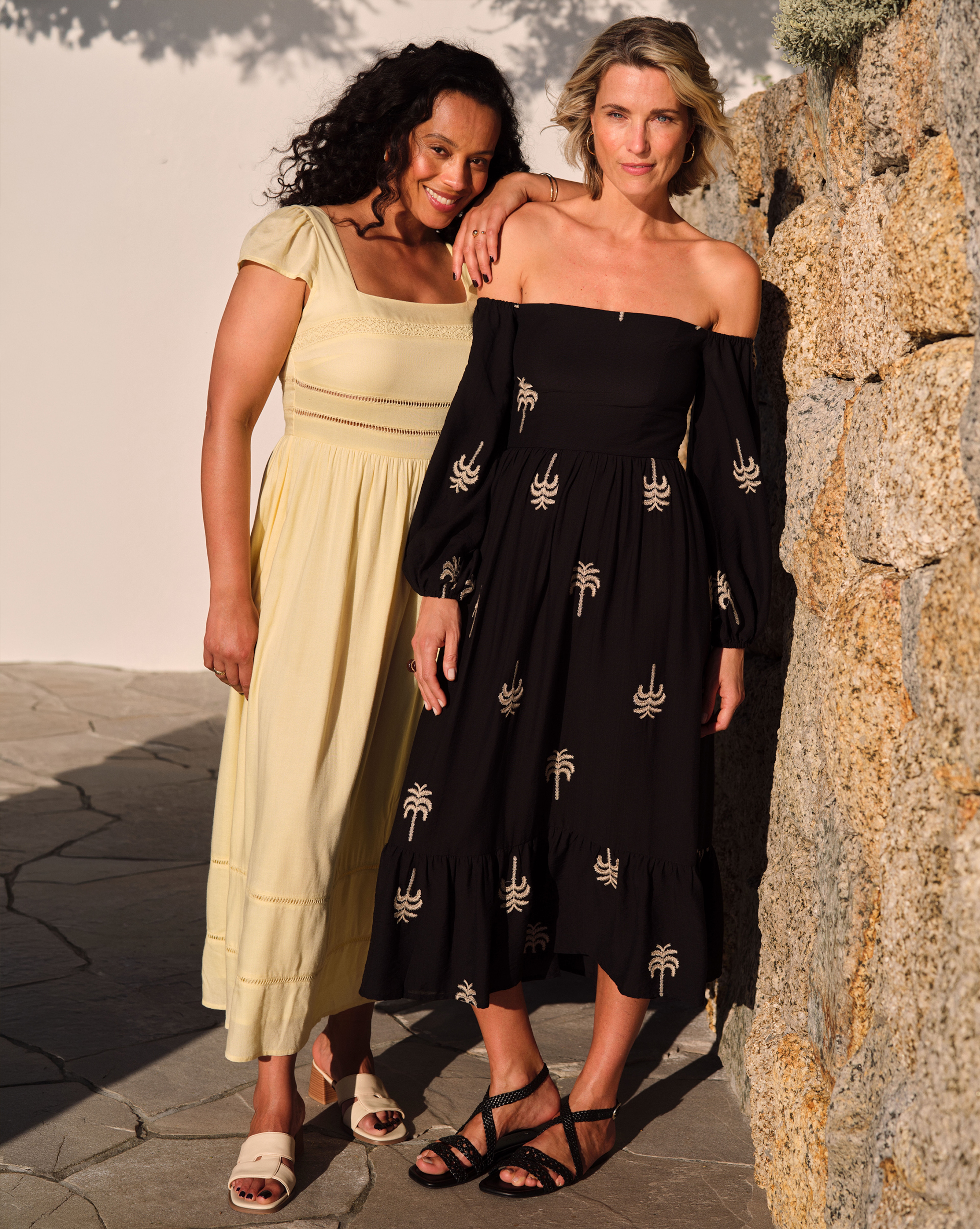 Two ladies wearing summer dresses in the sun.