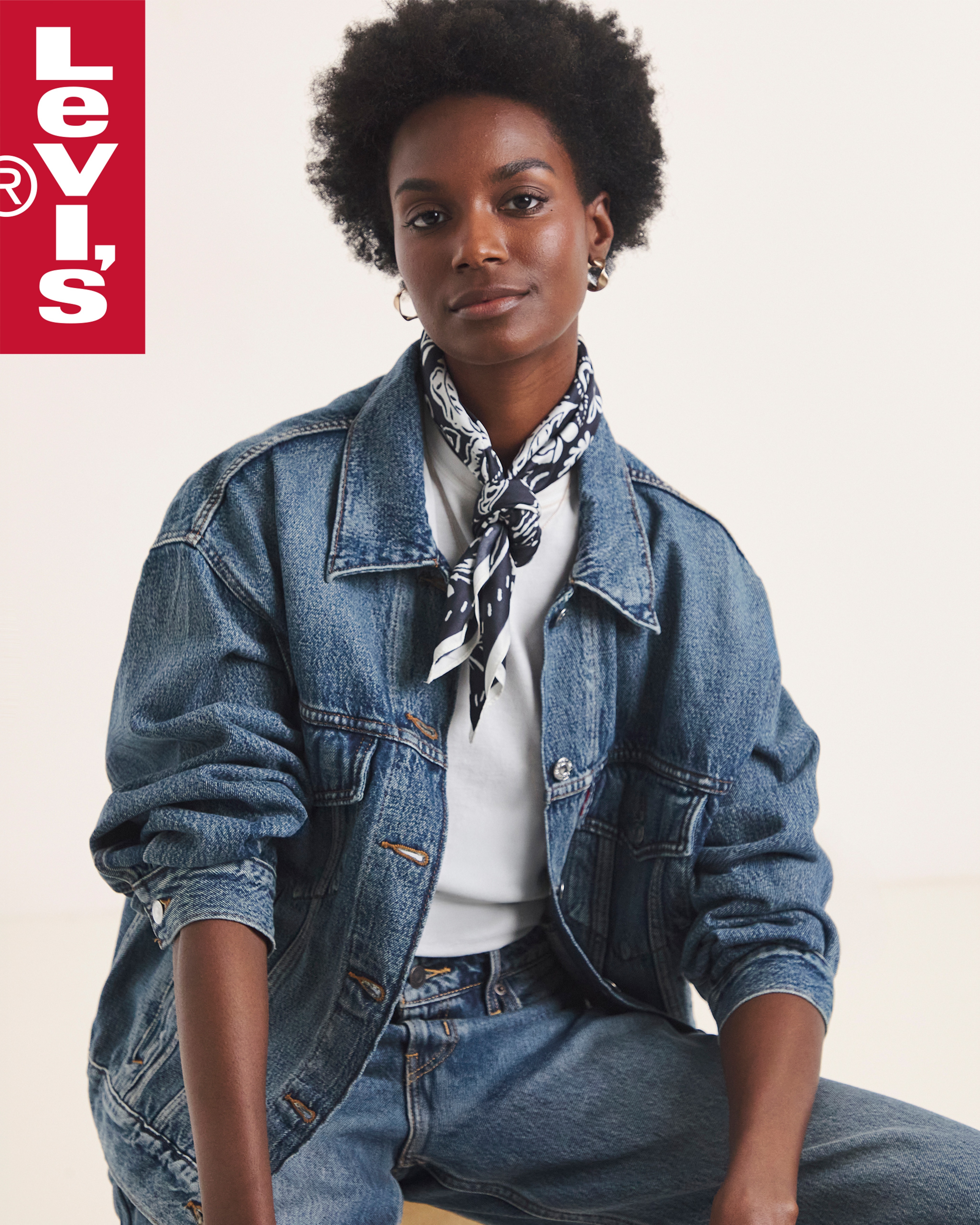 A woman sat down wearing Levi's denim clothing.