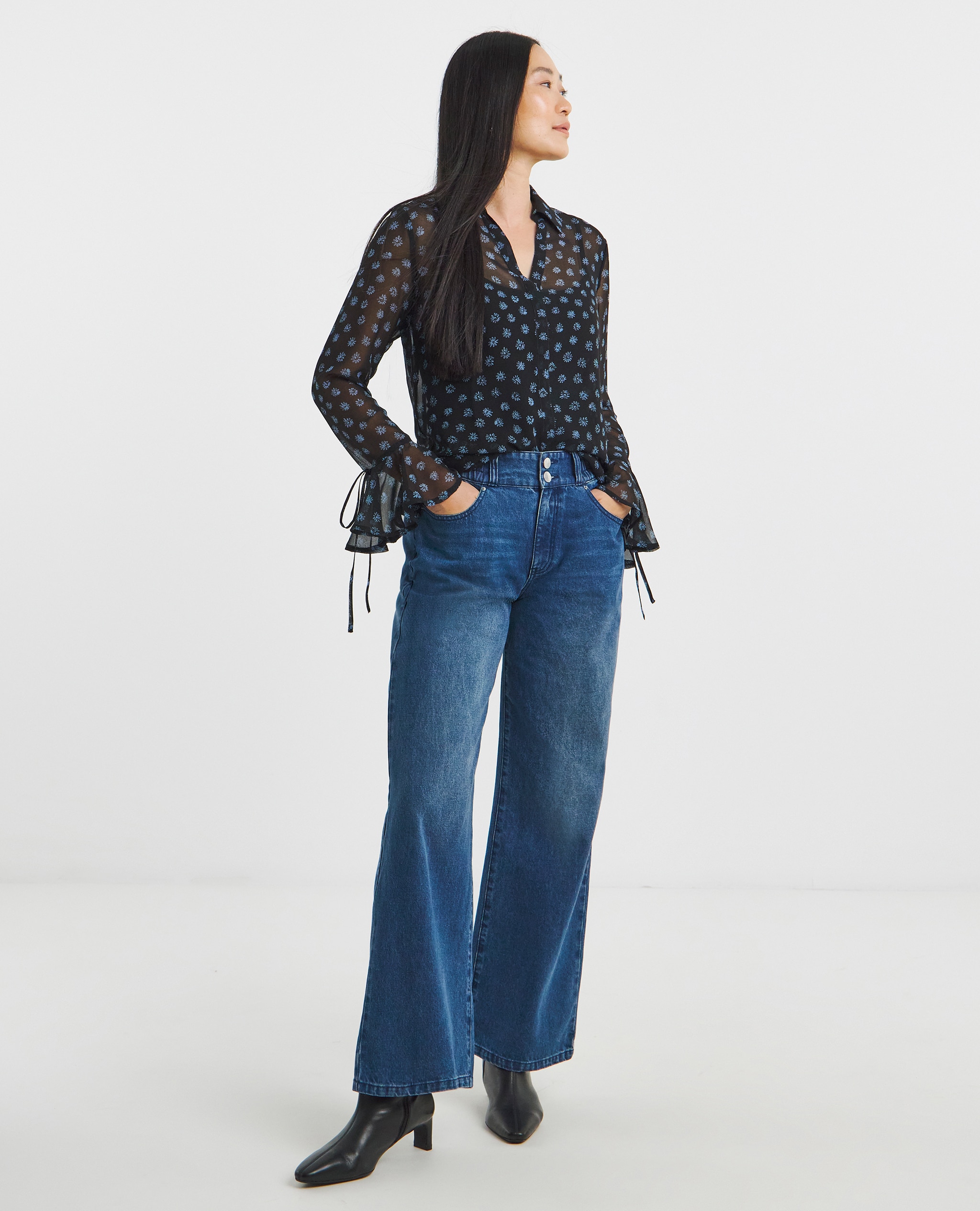 Model wears 24/7 Mid Wash Straight Leg Jean